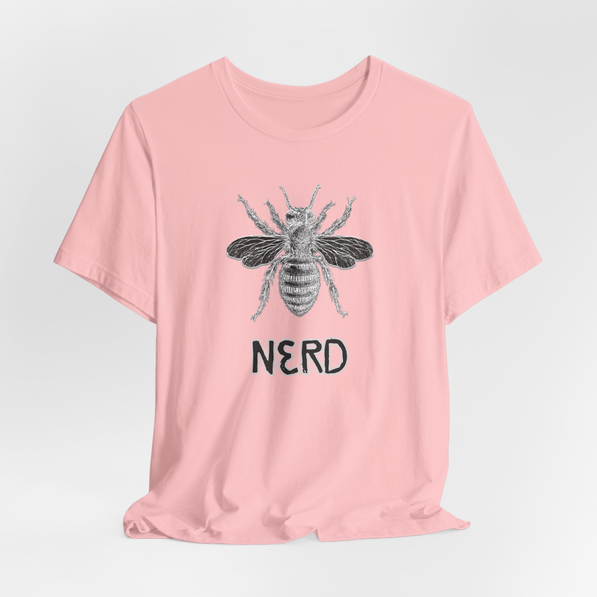 Pink t-shirt with a bee graphic and 'NERD' text on a light gray background