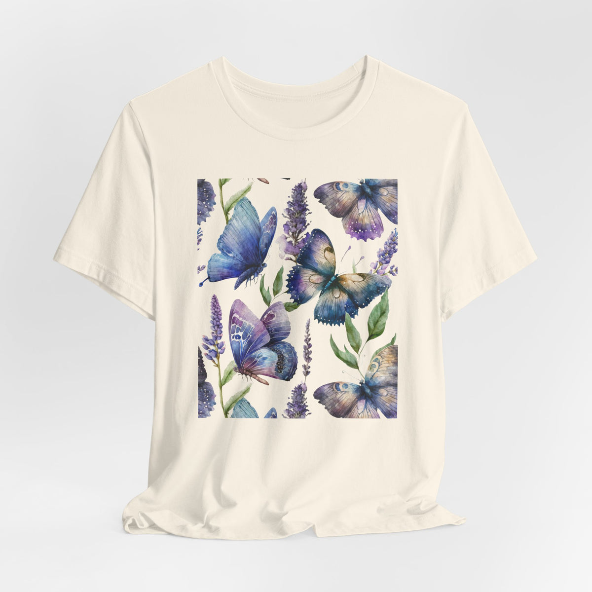 Beige t-shirt with blue butterfly design on a light gray background
