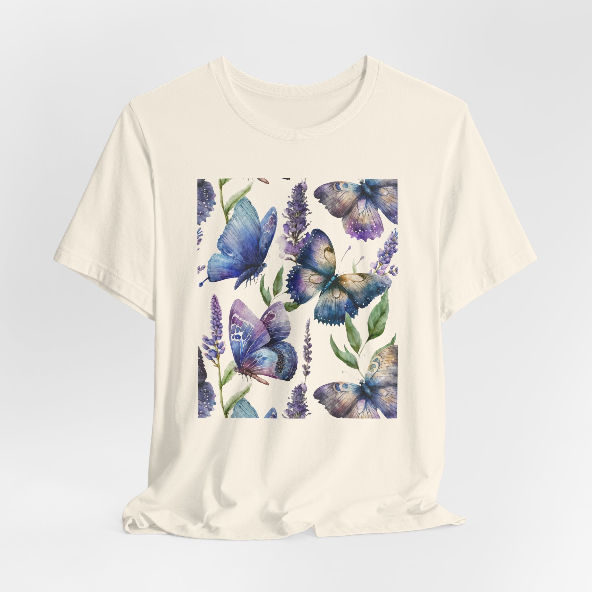 Beige t-shirt with blue butterfly design on a light gray background