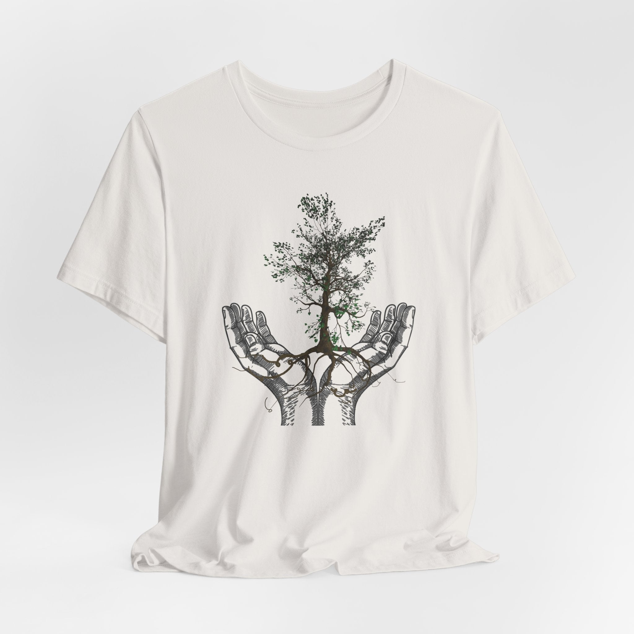 White t-shirt with a graphic of hands holding a tree on a white background