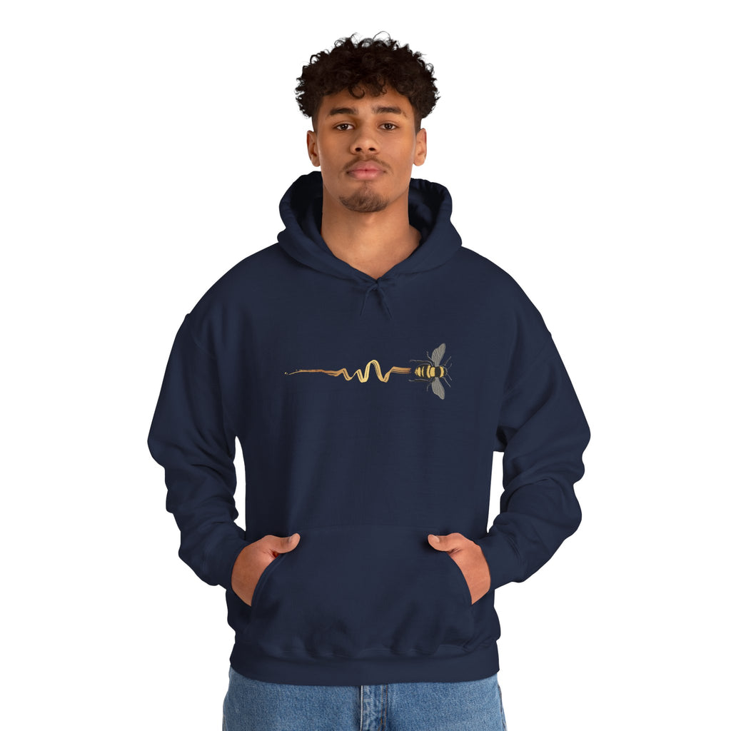 Person wearing navy blue hoodie with a bee design on a white background