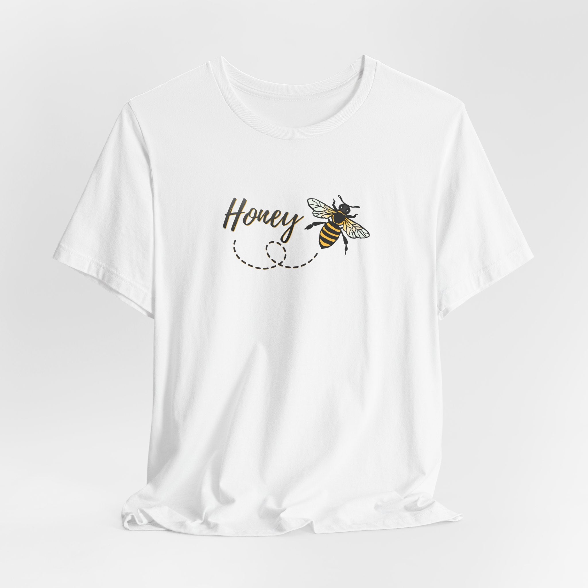White t-shirt with 'Honey' and bee design on a light gray background