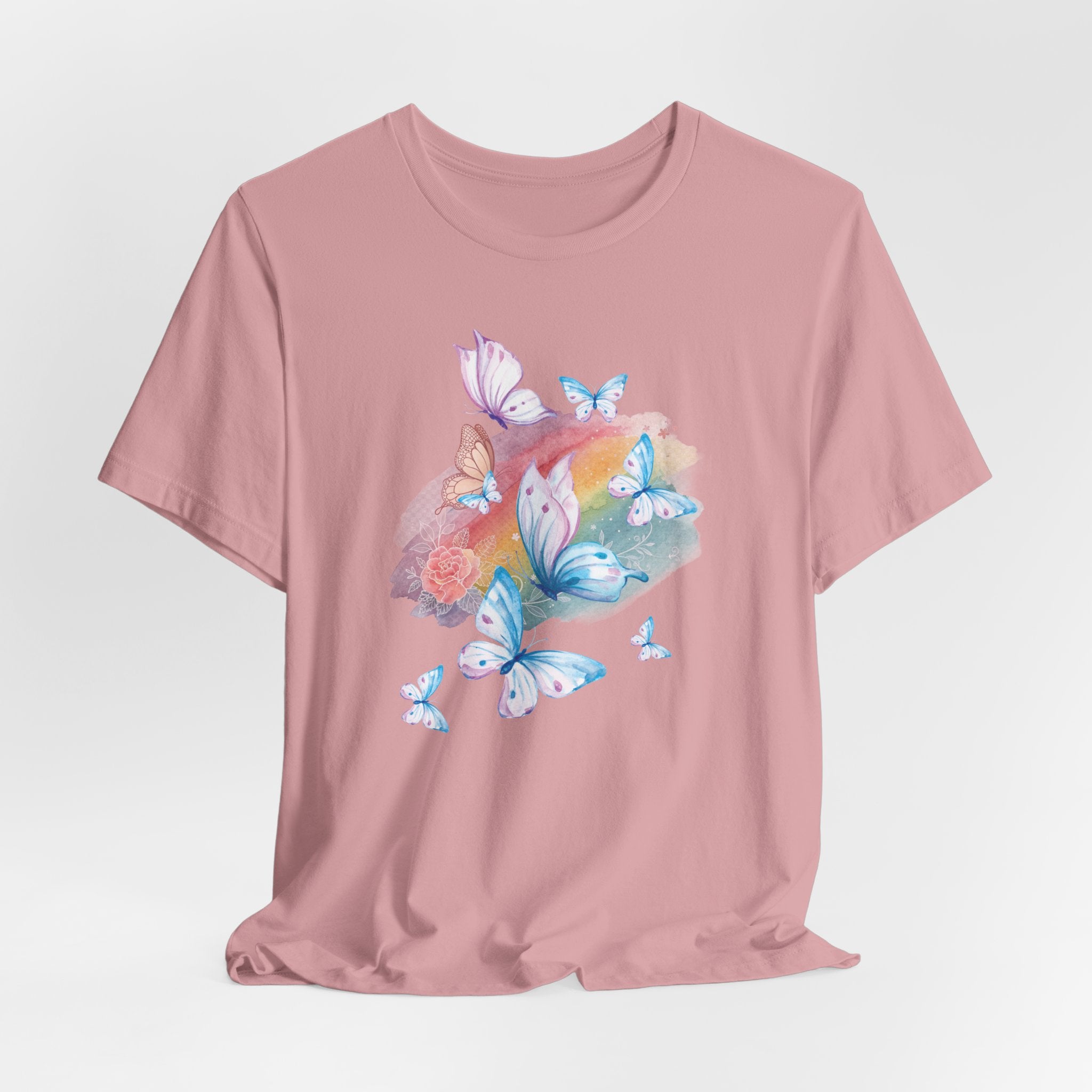 Pink t-shirt with butterfly design on a light gray background