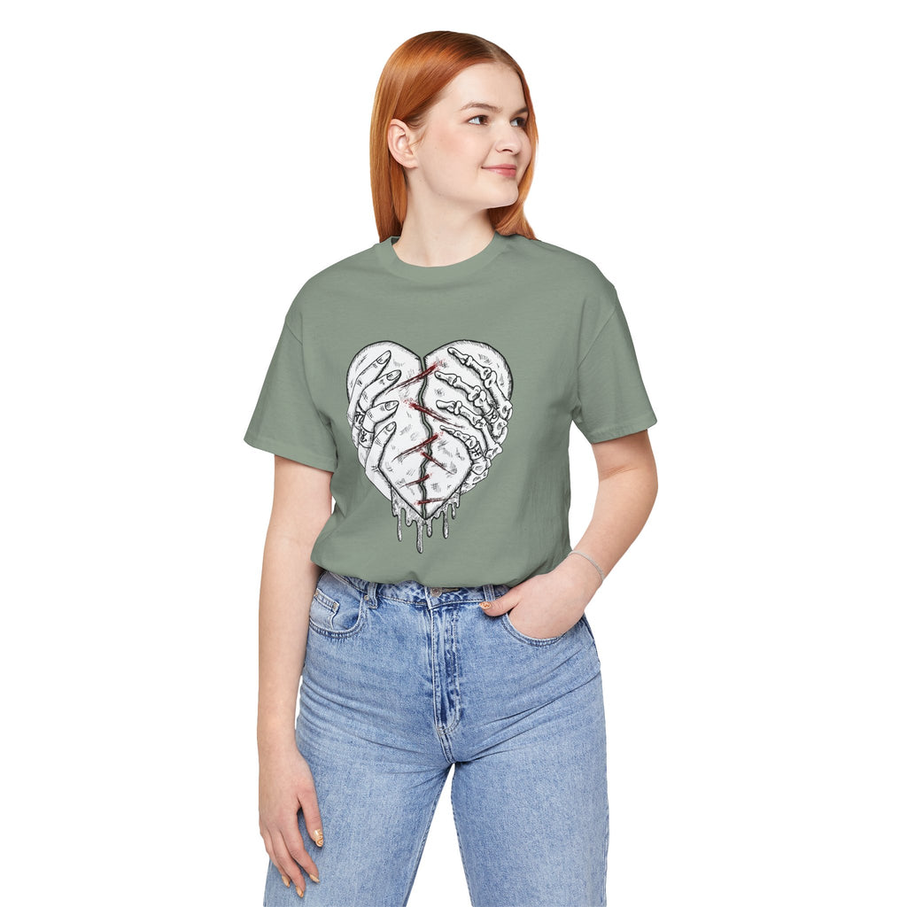 Person wearing a green t-shirt with a heart design on a white background
