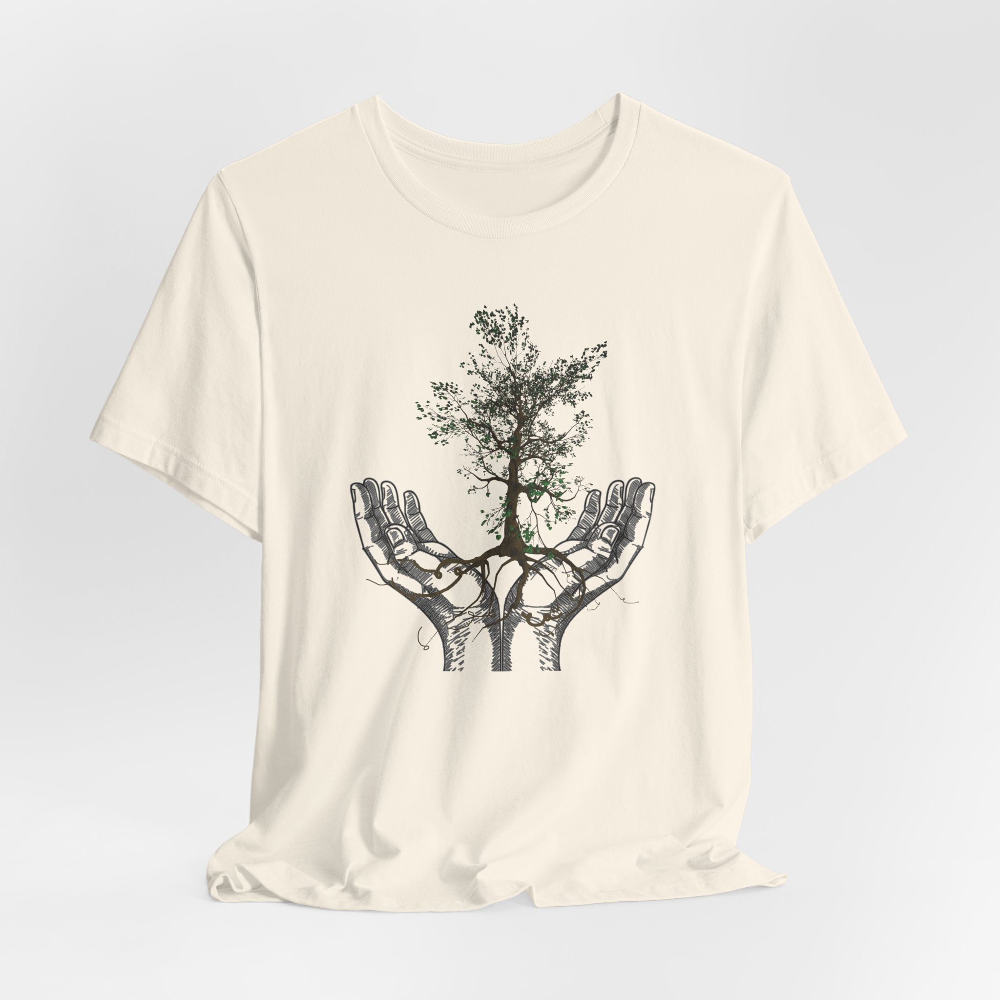 White t-shirt with a graphic of hands holding a tree on a light gray background