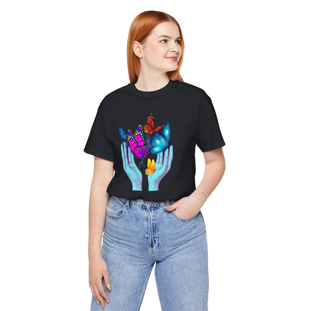 Person wearing a black t-shirt with colorful graphic design on a white background