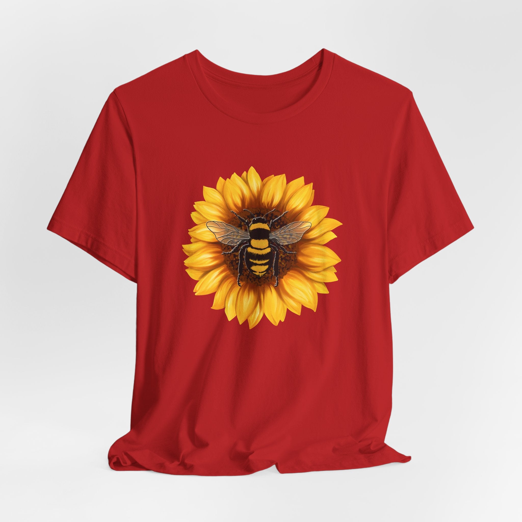 Red t-shirt with a sunflower and bee design on a white background