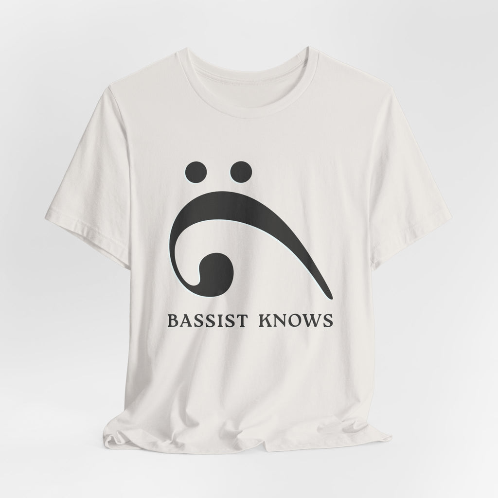 White t-shirt with black bass clef and 'Bassist Knows' text on a light gray background