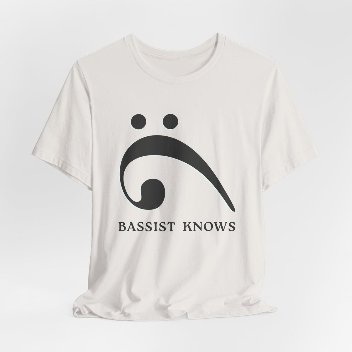 White t-shirt with black bass clef and 'Bassist Knows' text on a light gray background