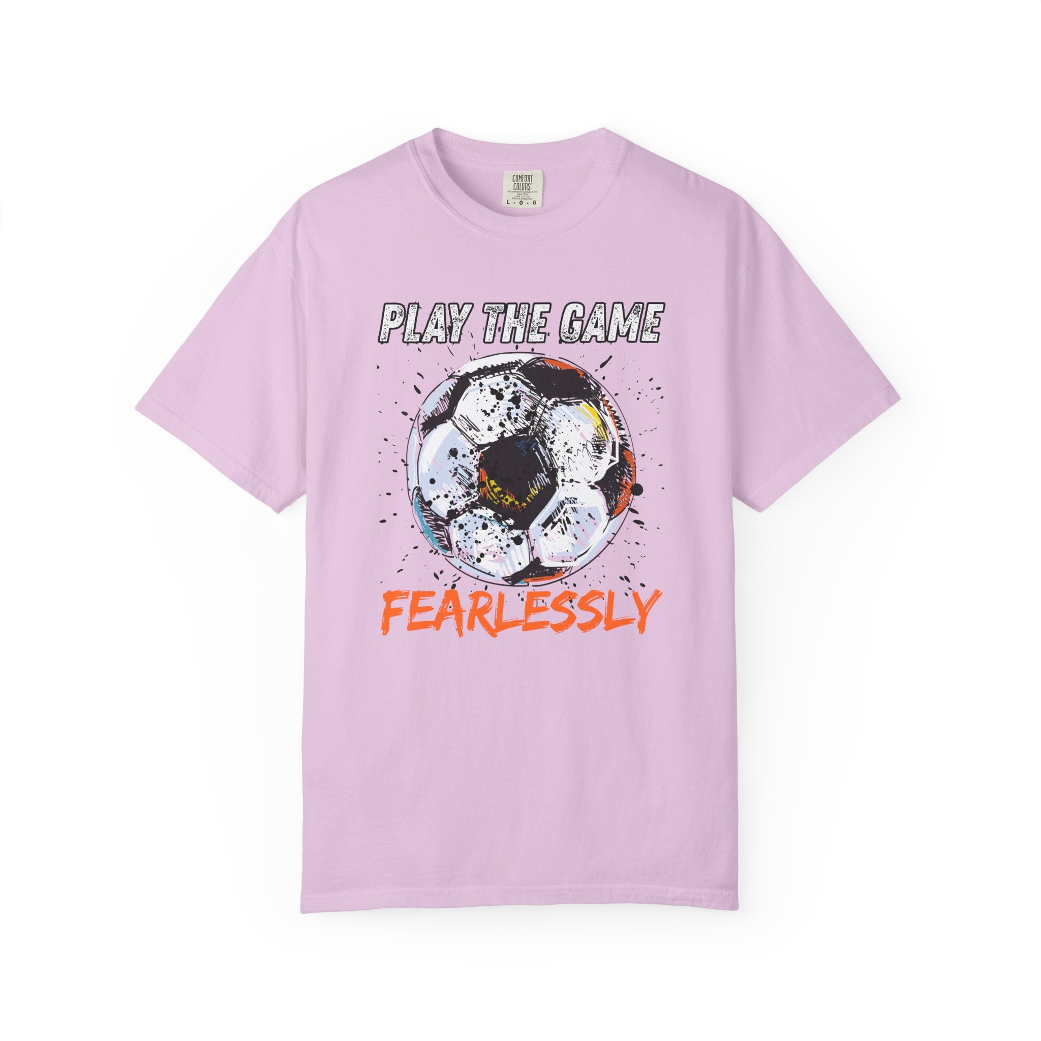 Pink t-shirt with dirty soccer ball graphic and play the game fearlessly text on a white background