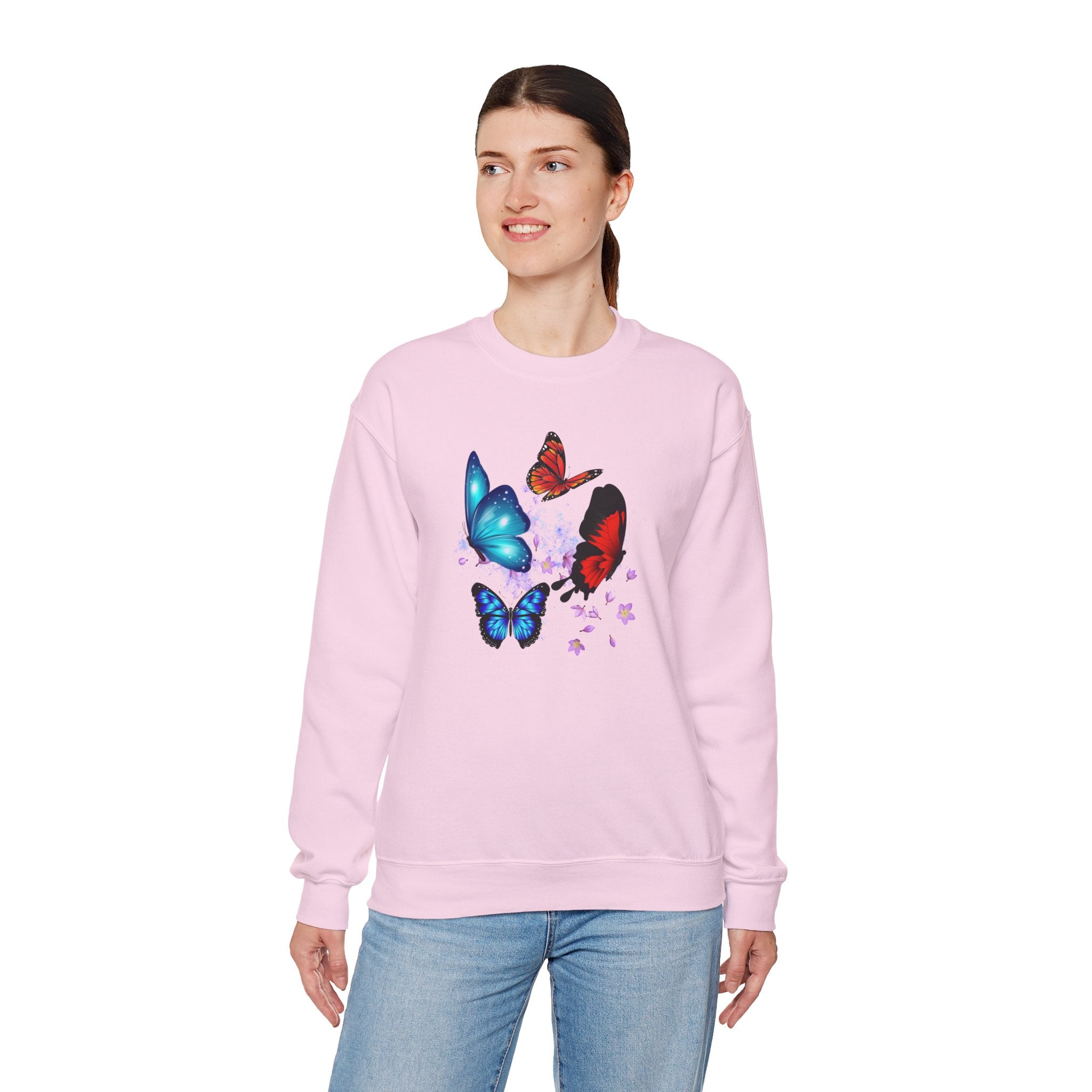 Person wearing a pink sweatshirt with butterfly designs on a white background