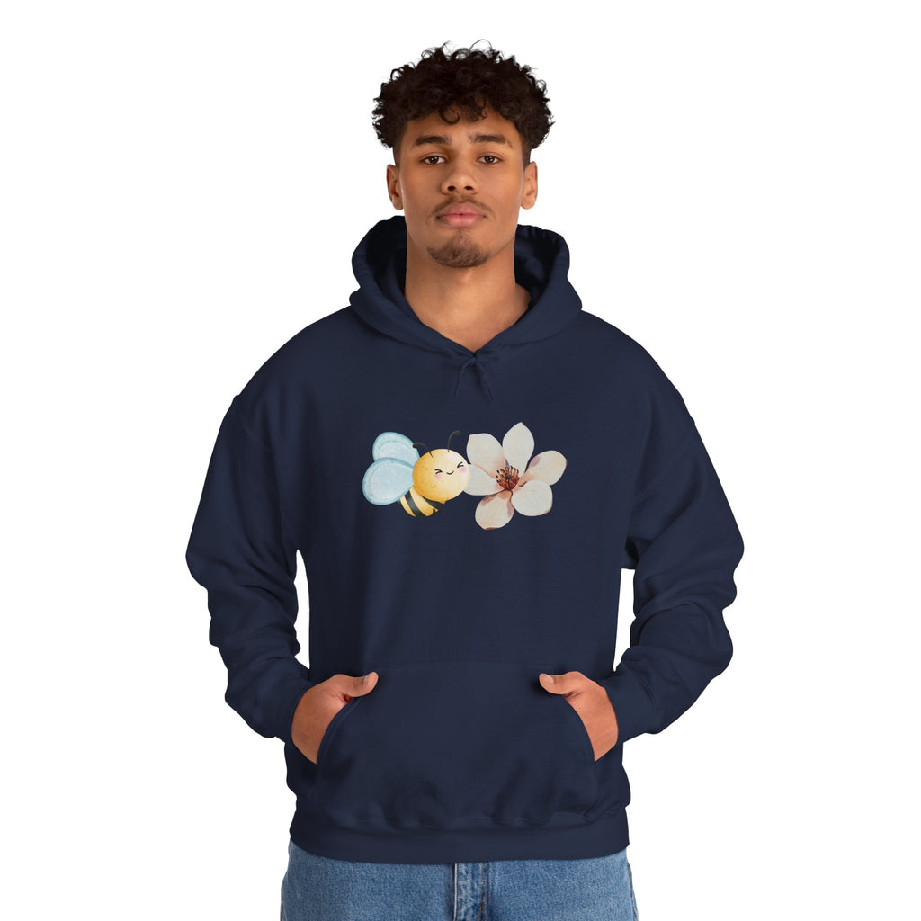 Person wearing a navy hoodie with a flower and bee design on a white background