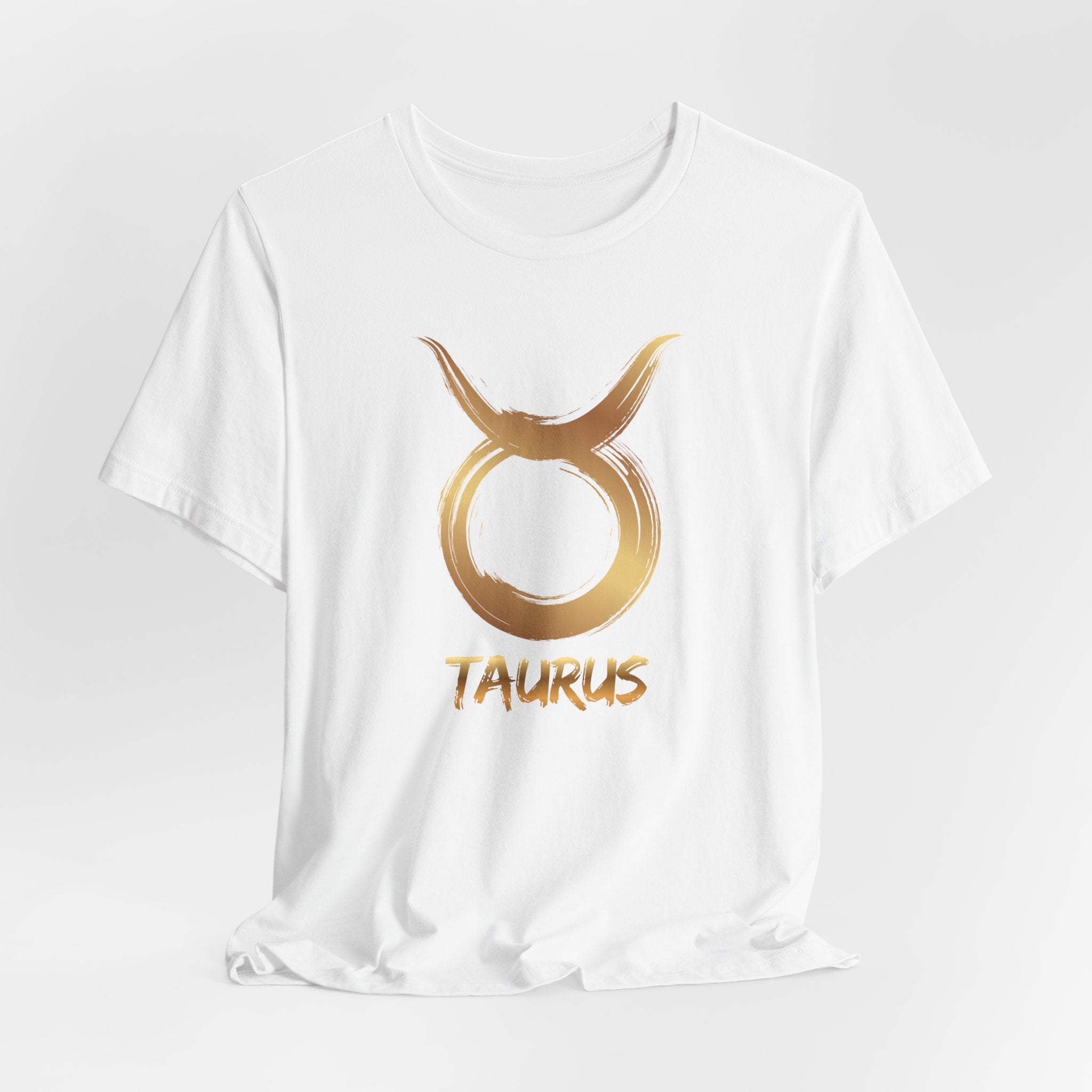 White t-shirt with gold Taurus zodiac symbol on a white background