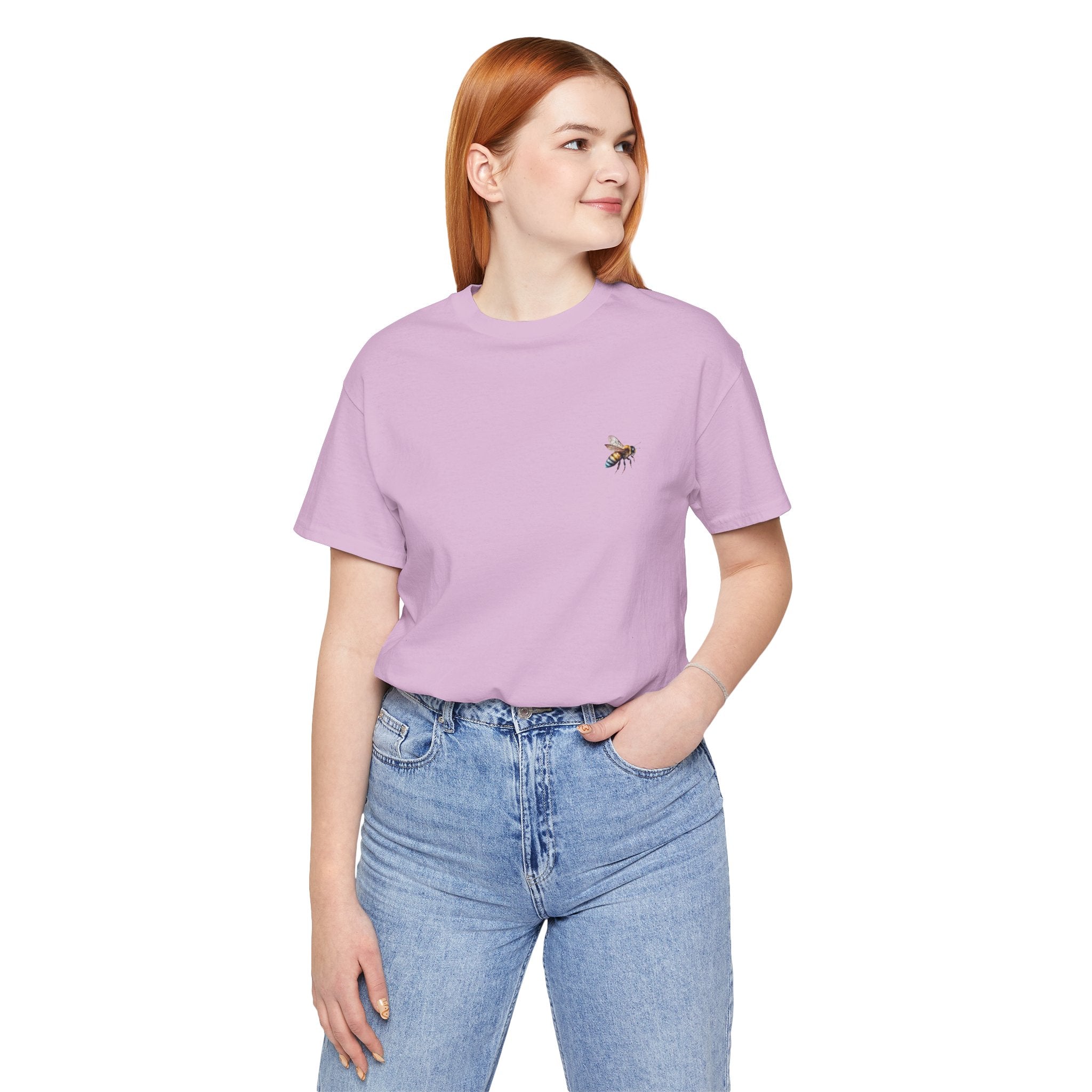 Person wearing a purple t-shirt with a bee design on a light gray background