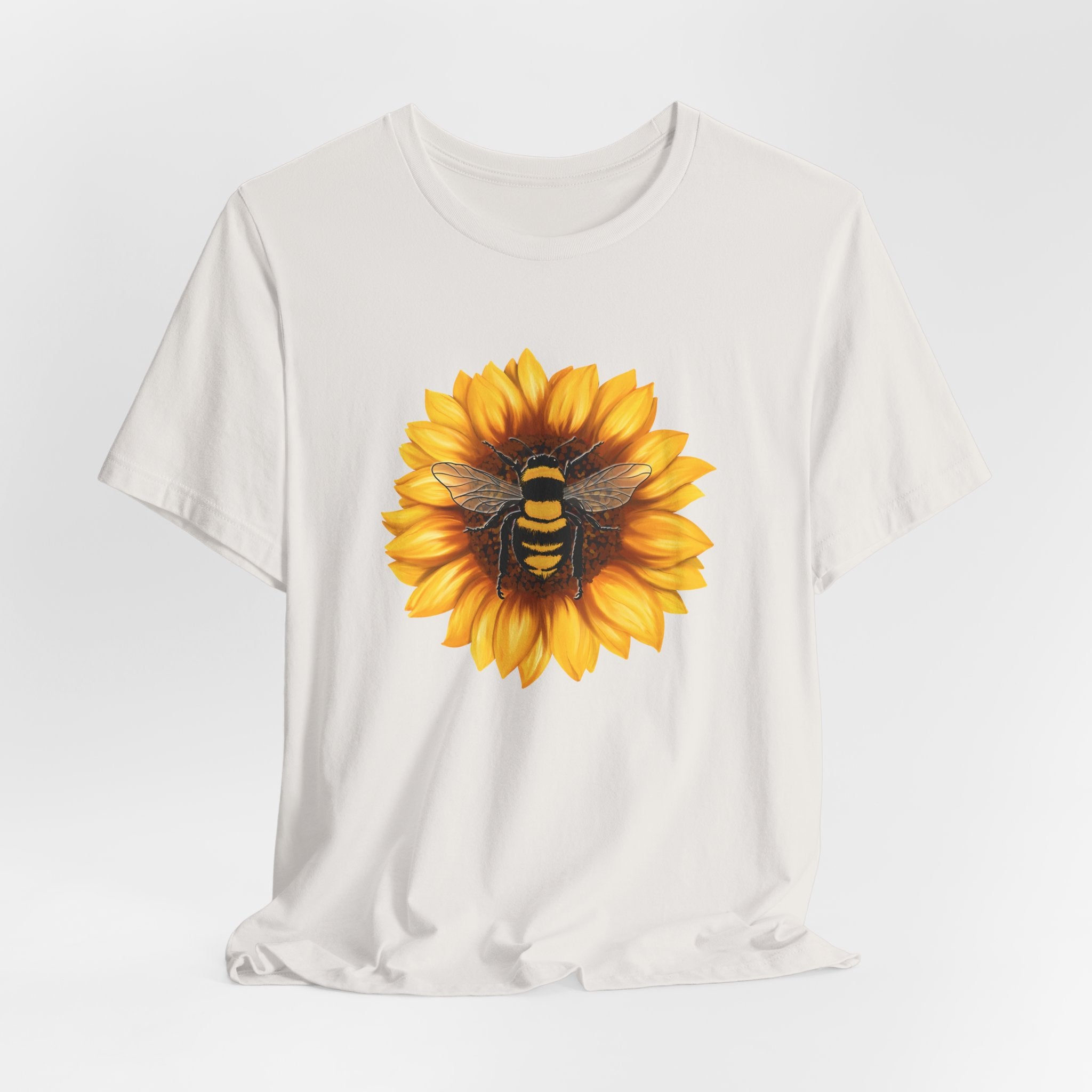 White t-shirt with a sunflower and bee design on a white background