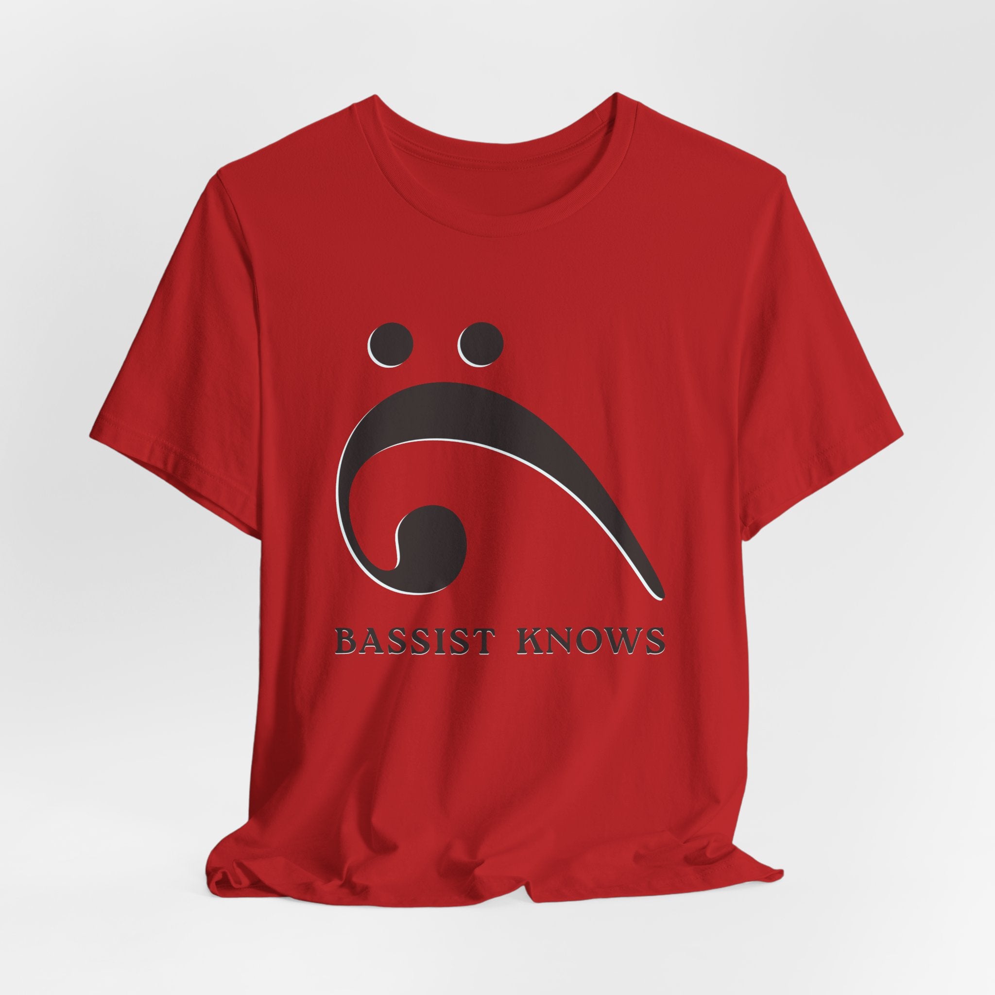 Red t-shirt with black bass clef and 'Bassist Knows' text on a light gray background