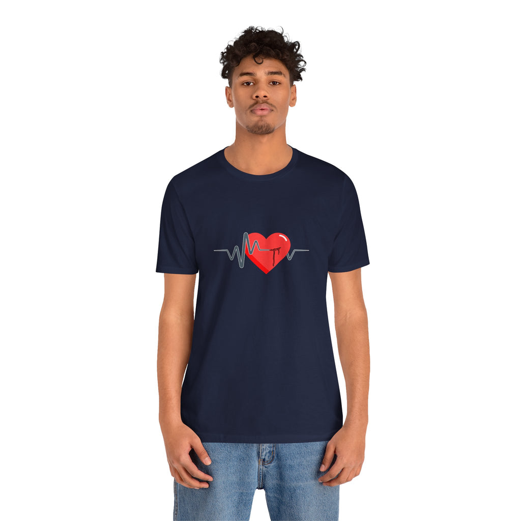 Person wearing a navy blue t-shirt with a red heart and heartbeat line design on a white background