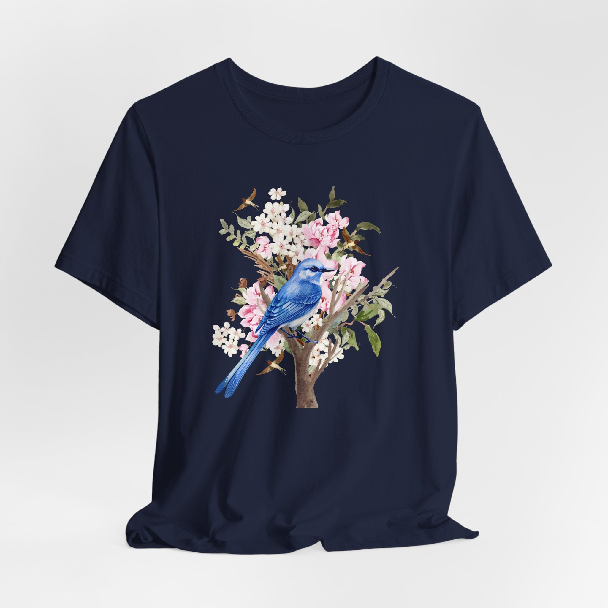 Navy blue t-shirt with a blue bird and floral design on a light gray background