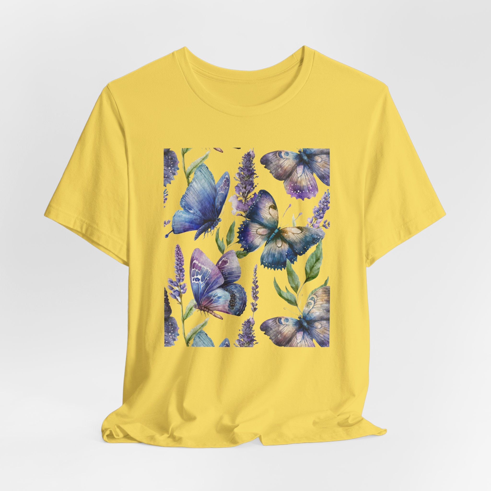 Yellow t-shirt with blue butterfly design on a white background