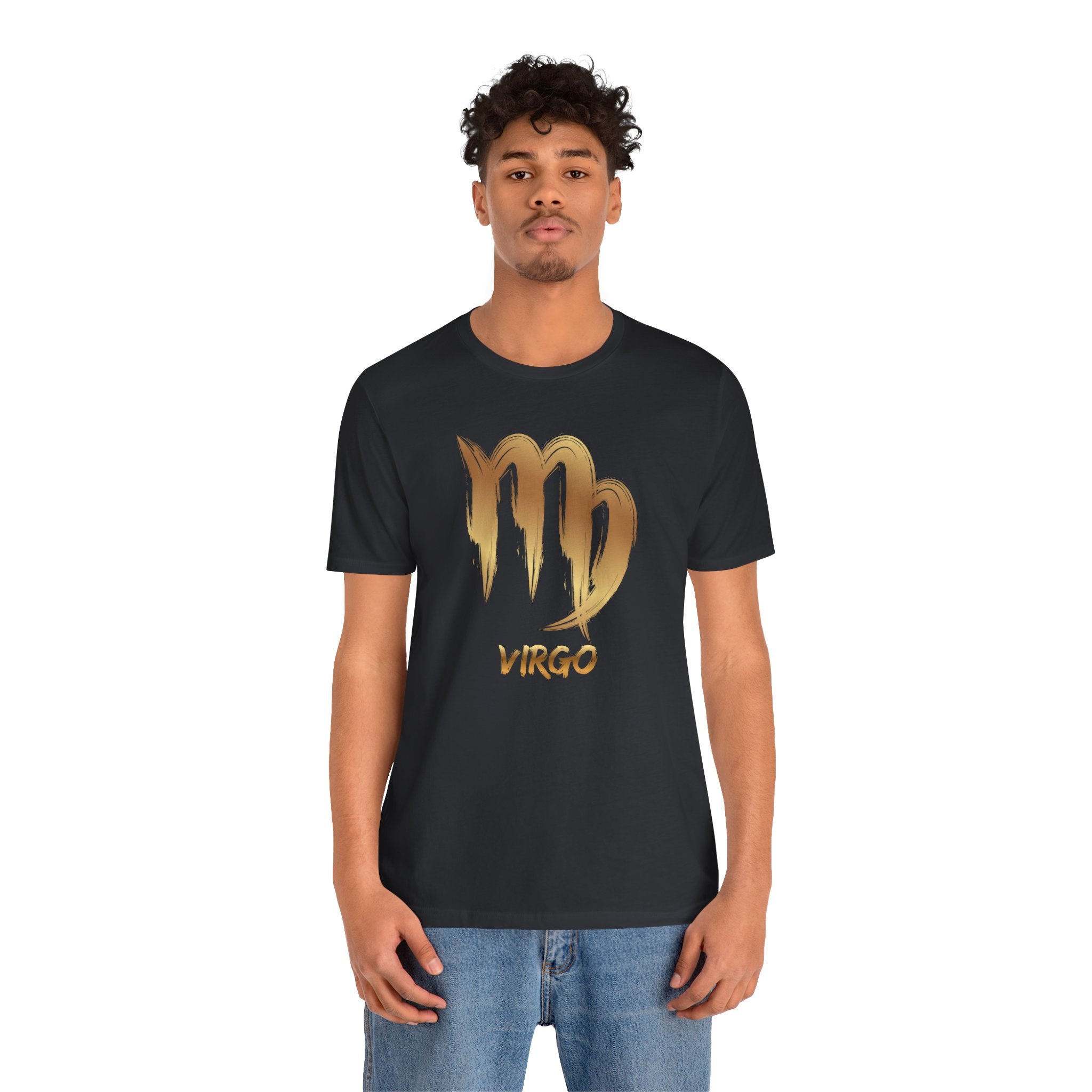 Person wearing a black t-shirt with a gold Virgo zodiac sign design on a white background