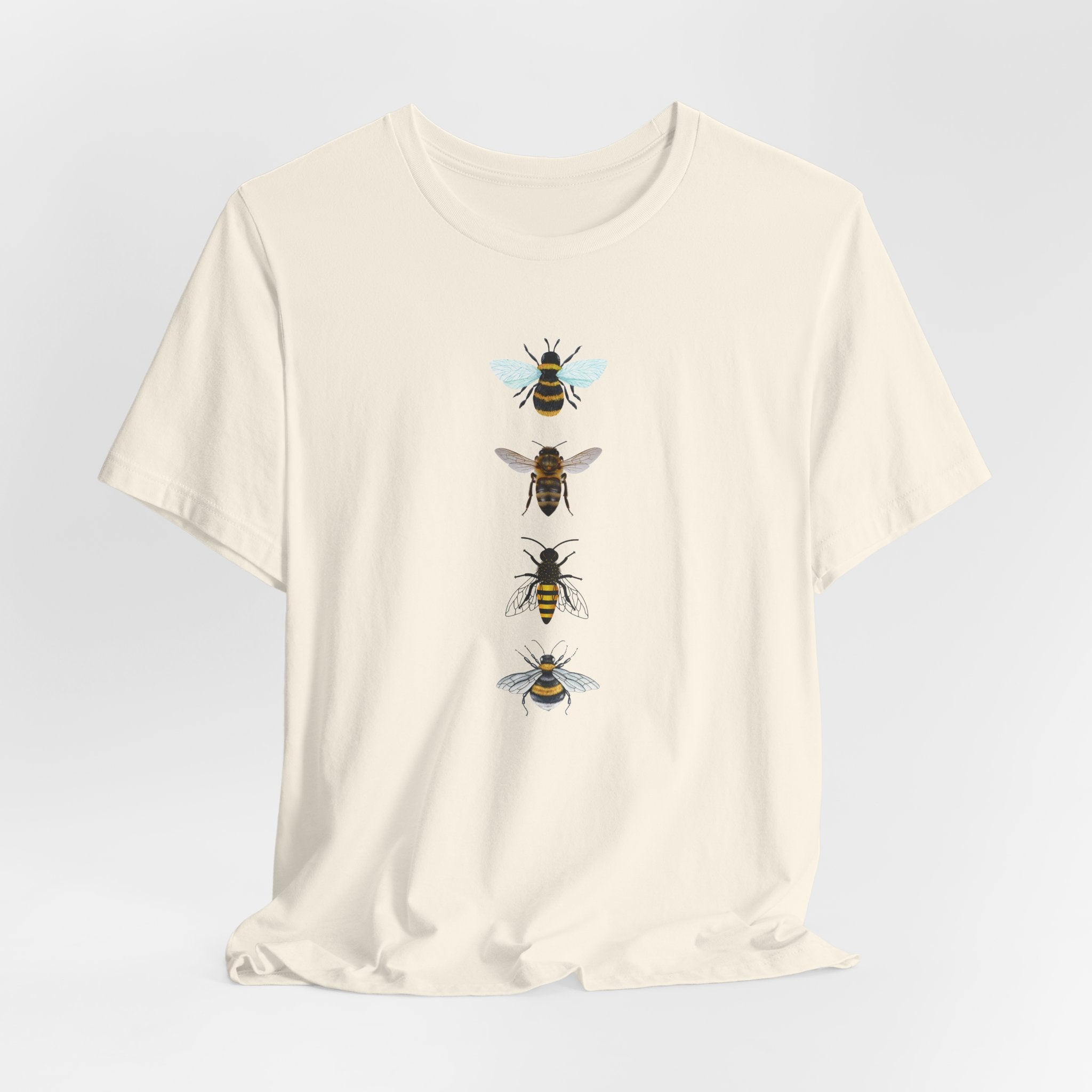 Beige t-shirt with bee illustrations on a light gray background