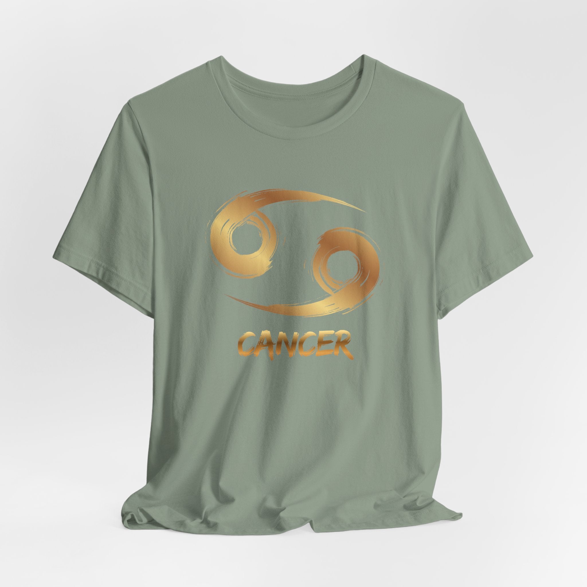 Green t-shirt with gold Cancer zodiac symbol on a light gray background
