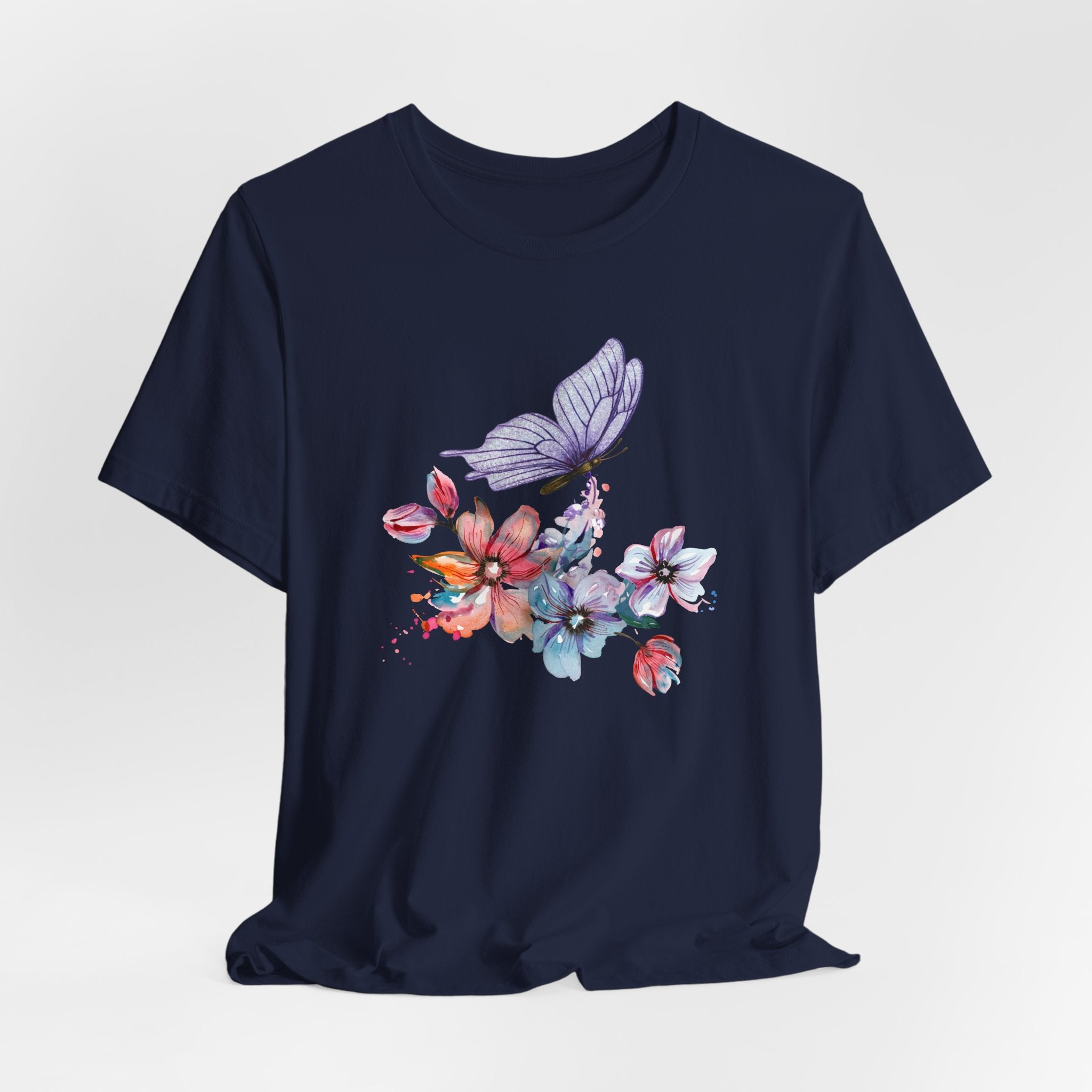 Navy blue t-shirt with colorful floral and butterfly design on a light gray background