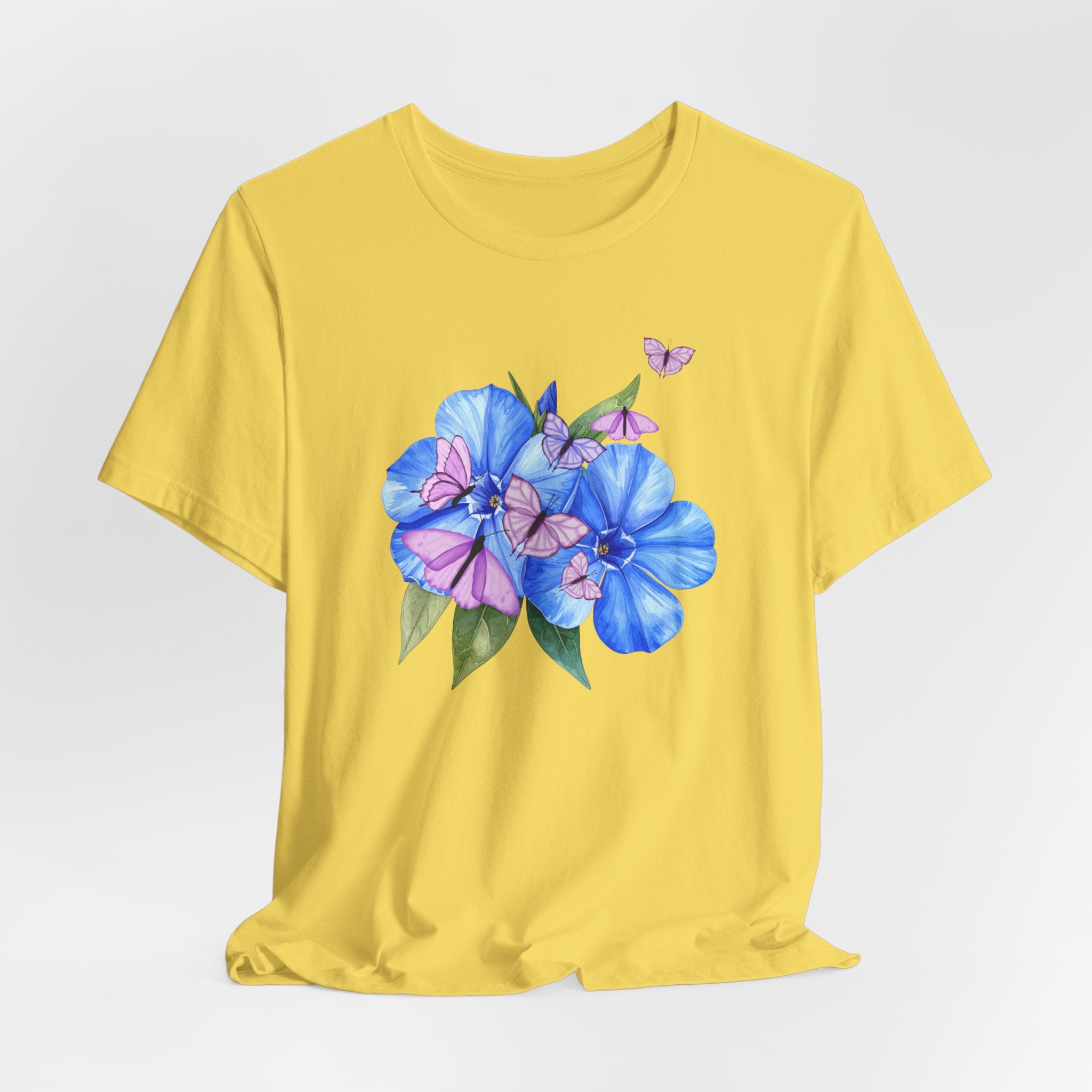 Yellow t-shirt with blue flowers and pink butterflies on a white background