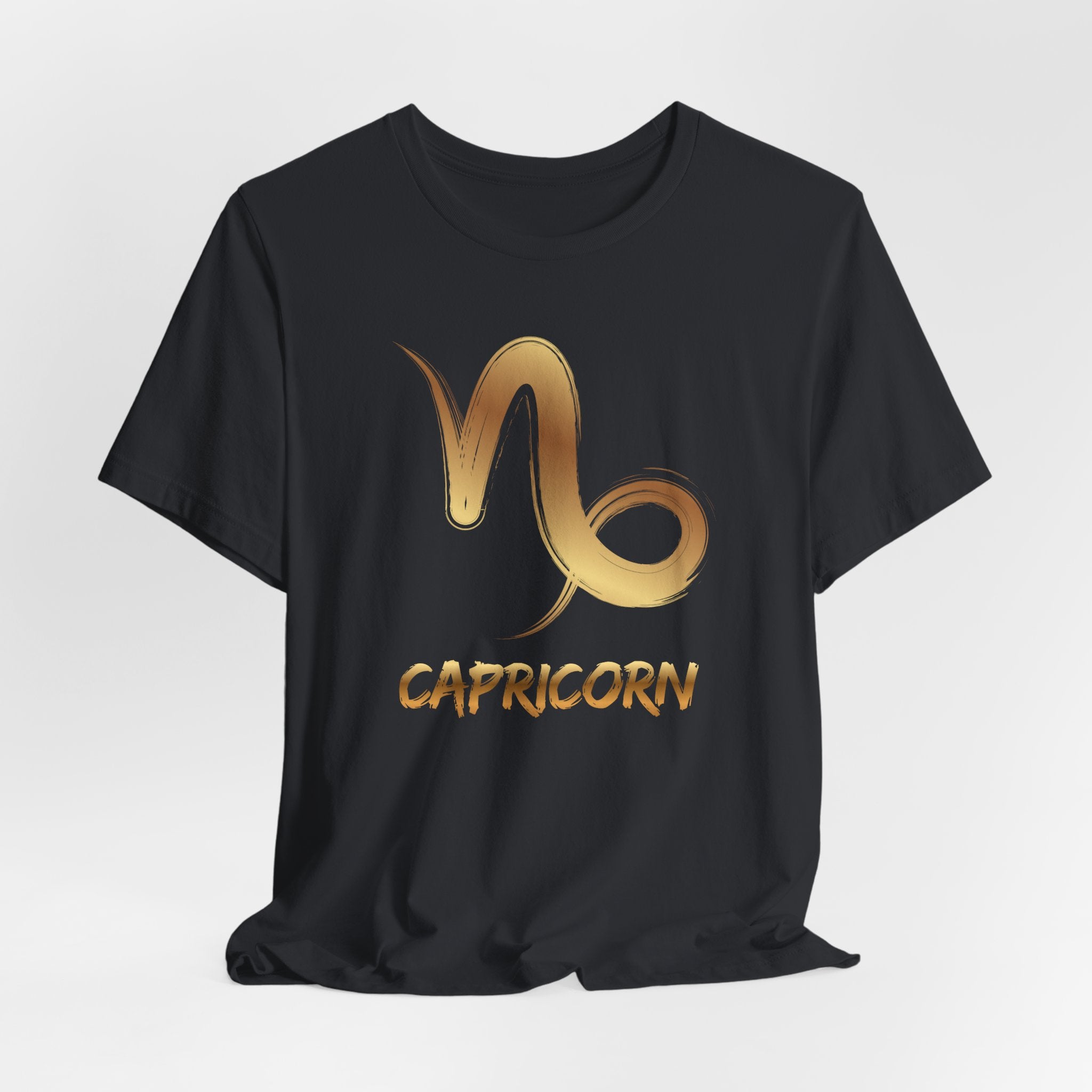 Black t-shirt with gold Capricorn zodiac symbol on a white background