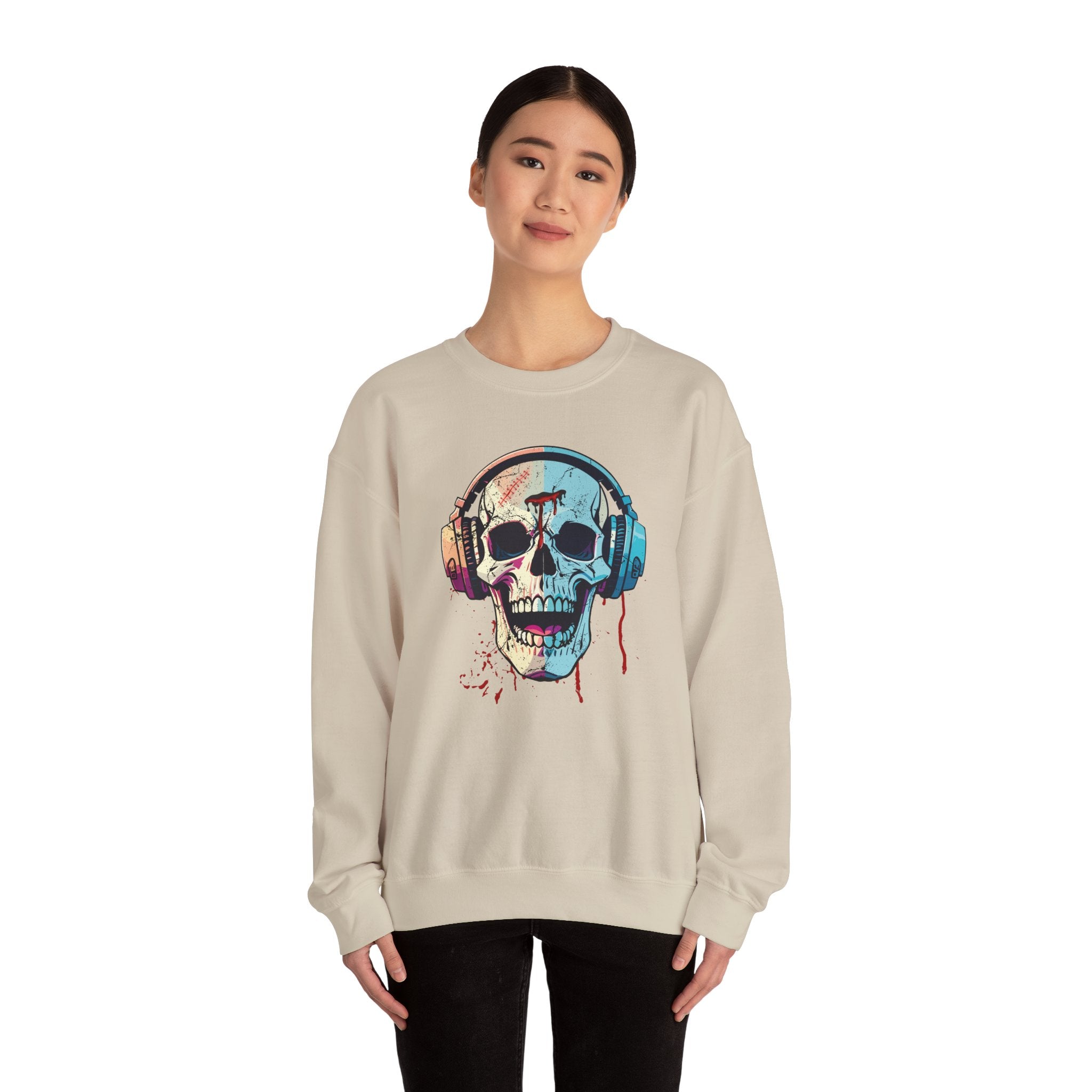 Person wearing a beige sweatshirt with a colorful skull and headphones design on a white background