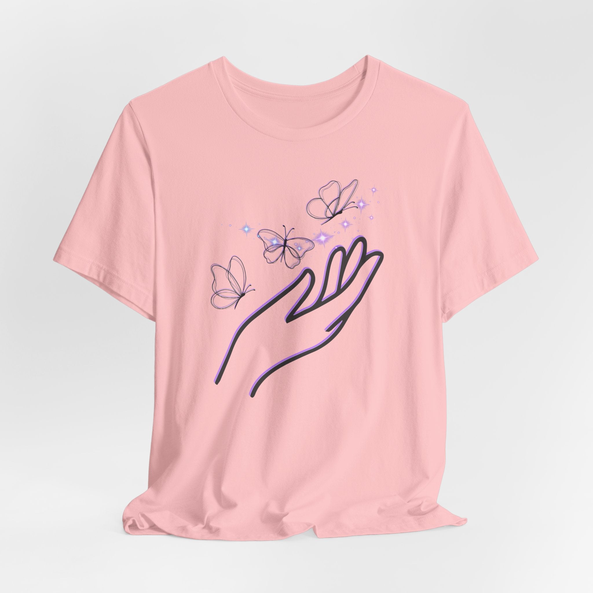 Pink t-shirt with a design of a hand and butterflies on a light gray background