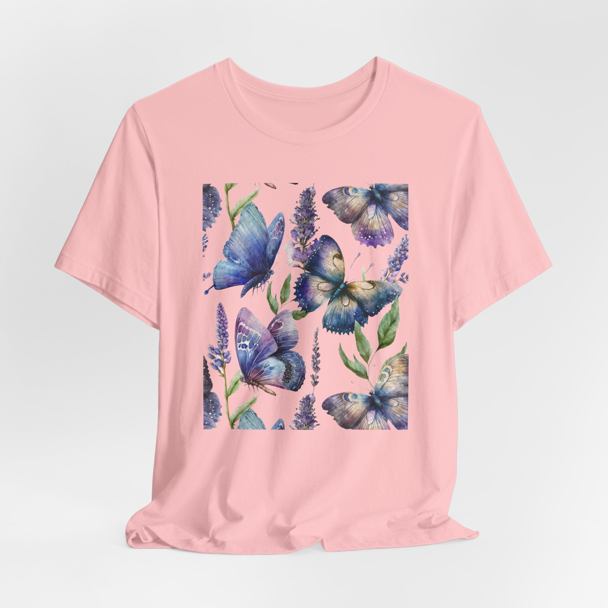 Pink t-shirt with blue butterfly design on a light gray background