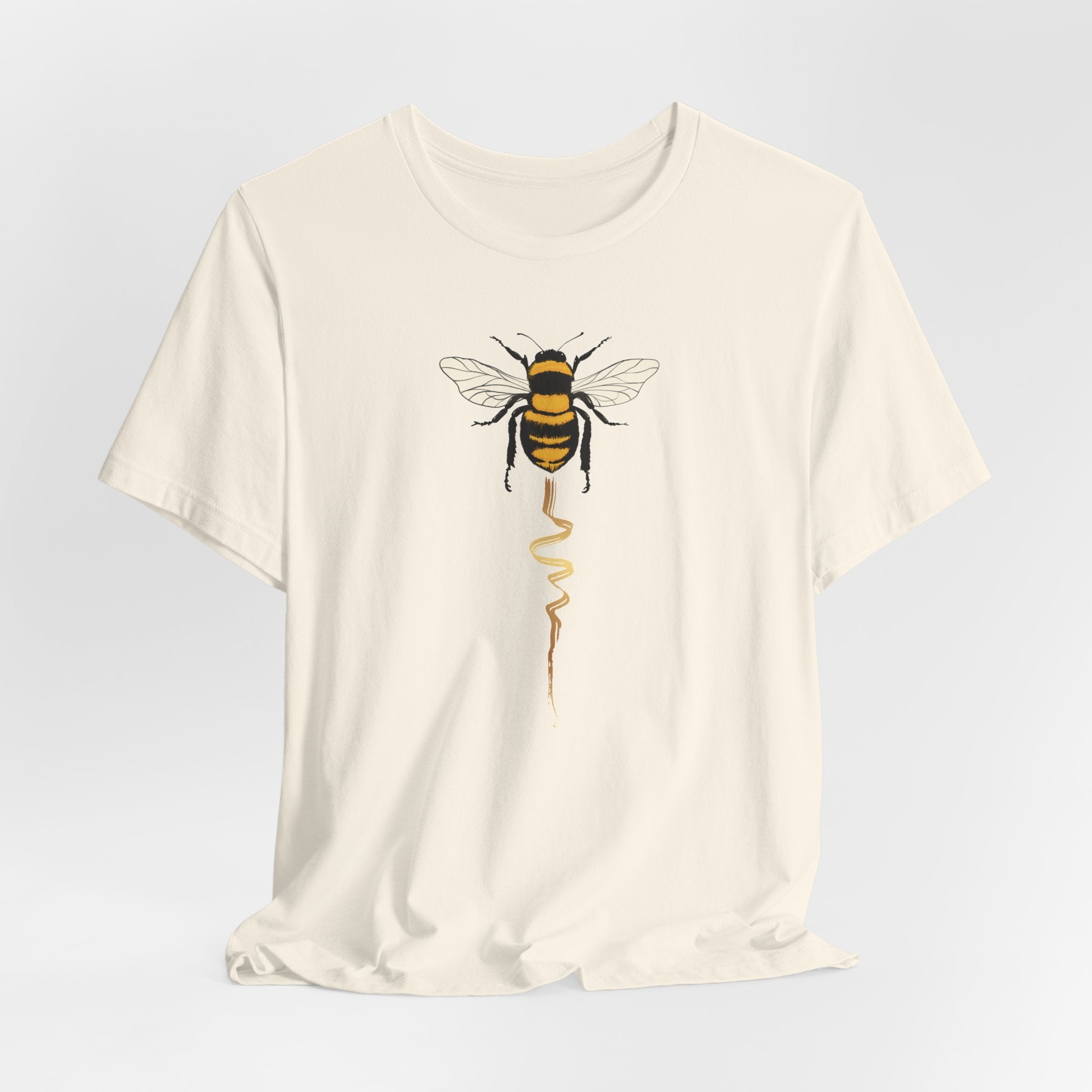 Beige t-shirt with a bee design on a light gray background
