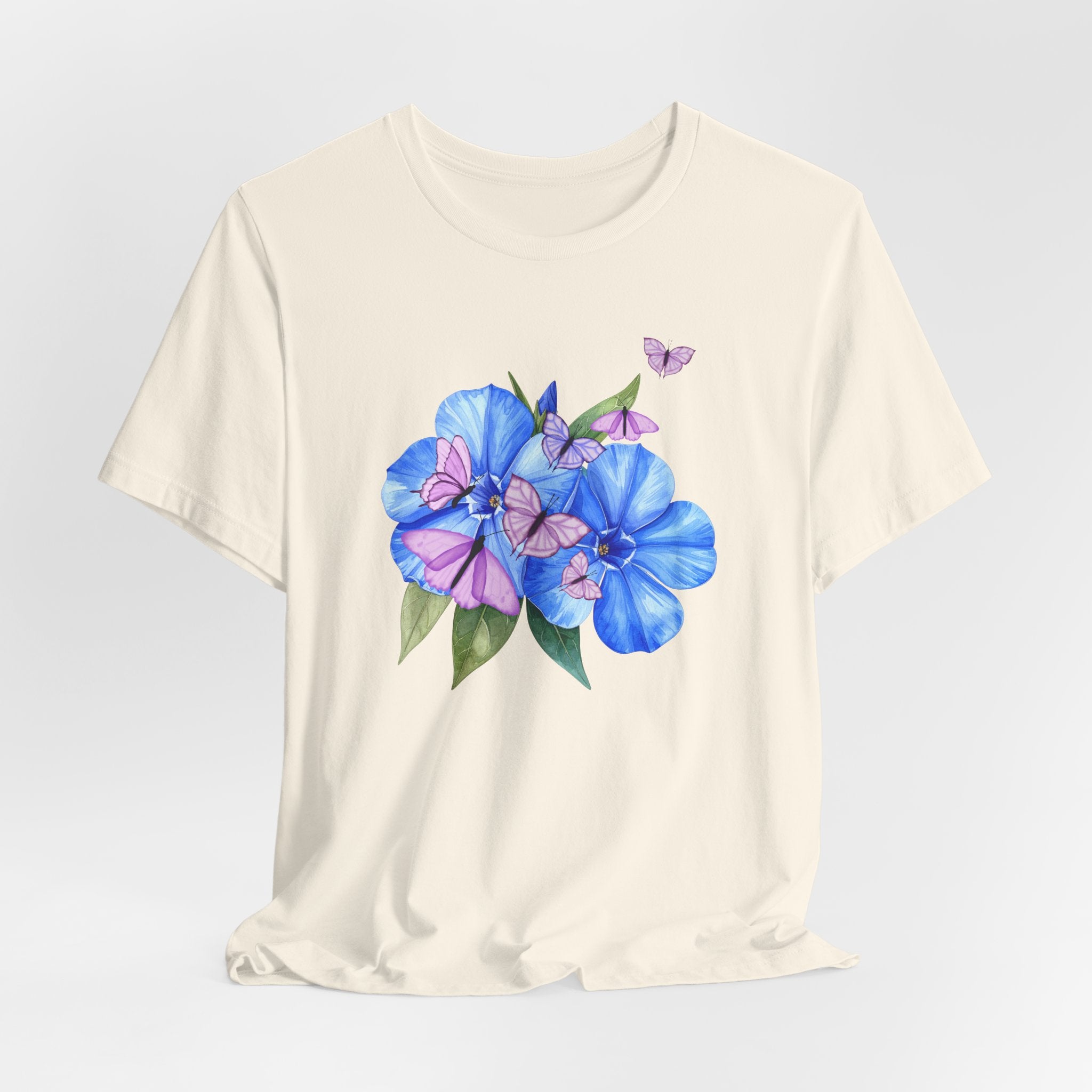 White t-shirt with blue and pink floral design on a light gray background
