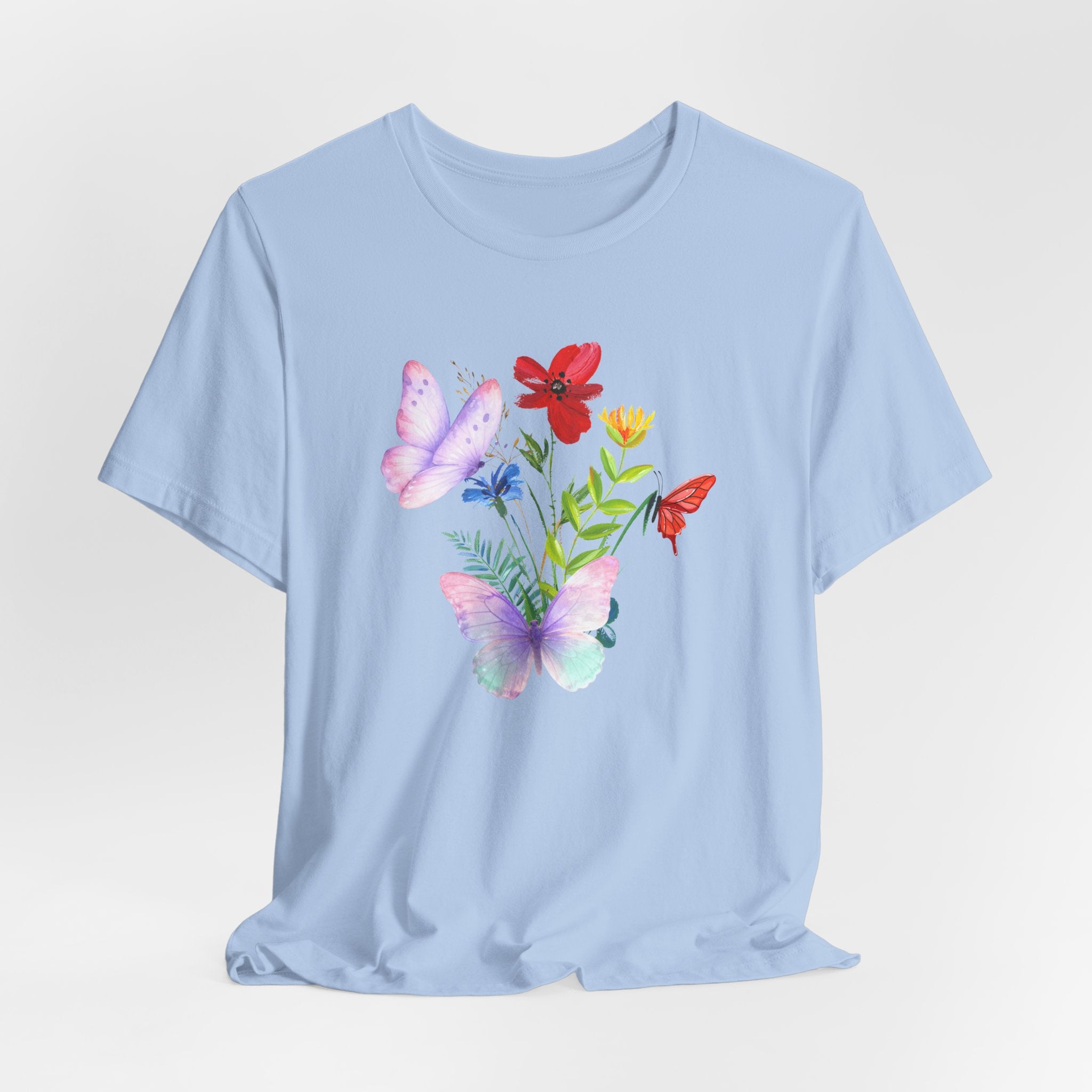 Light blue t-shirt with butterfly and flower design on a light gray background