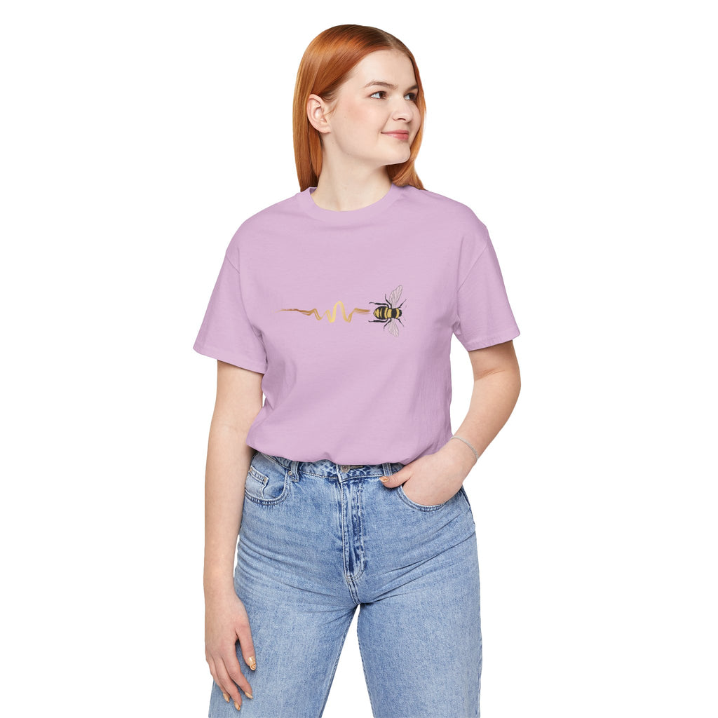 Person wearing a purple t-shirt with a bee and pulse line design on a light gray background