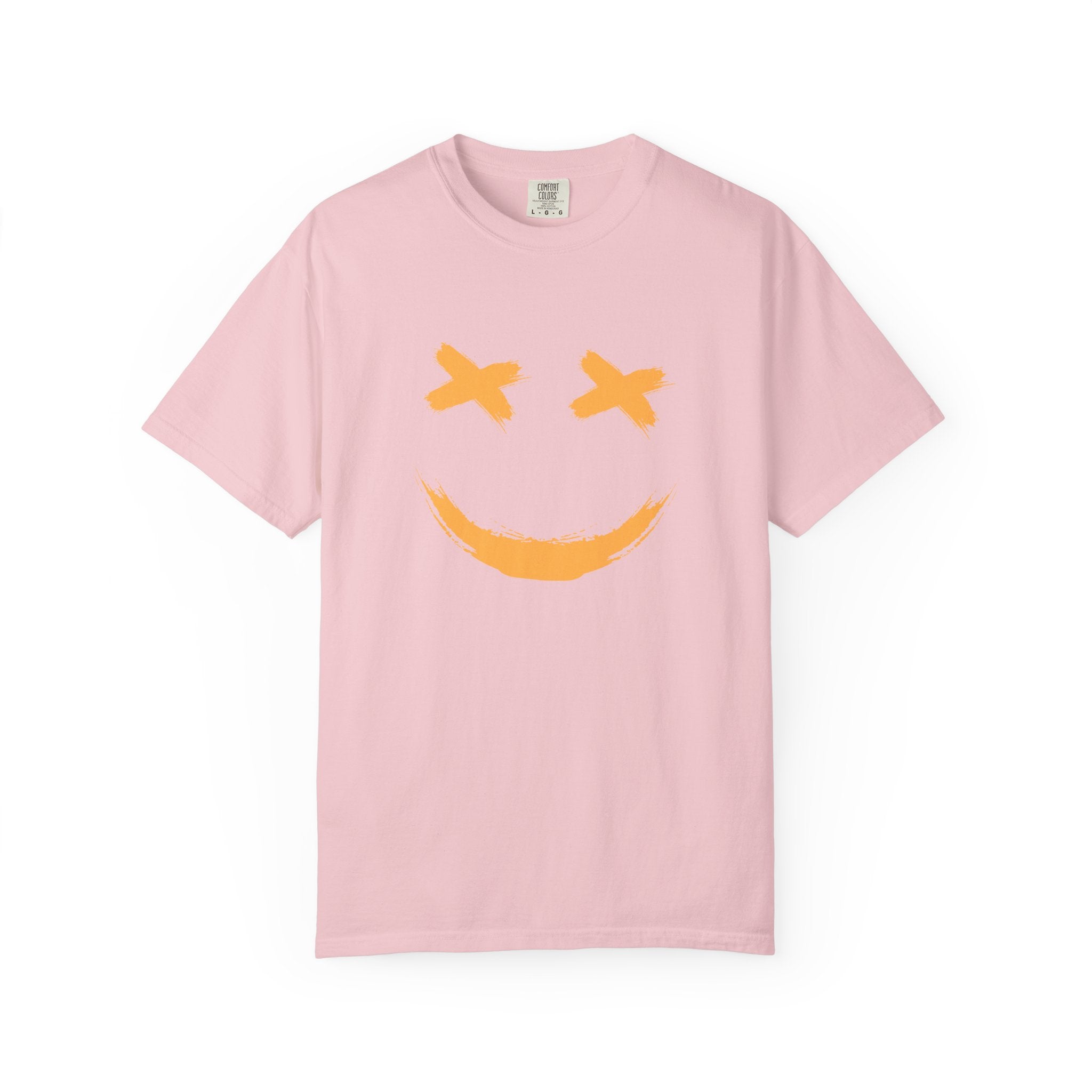 Pink t-shirt with a yellow smiley face design on a white background