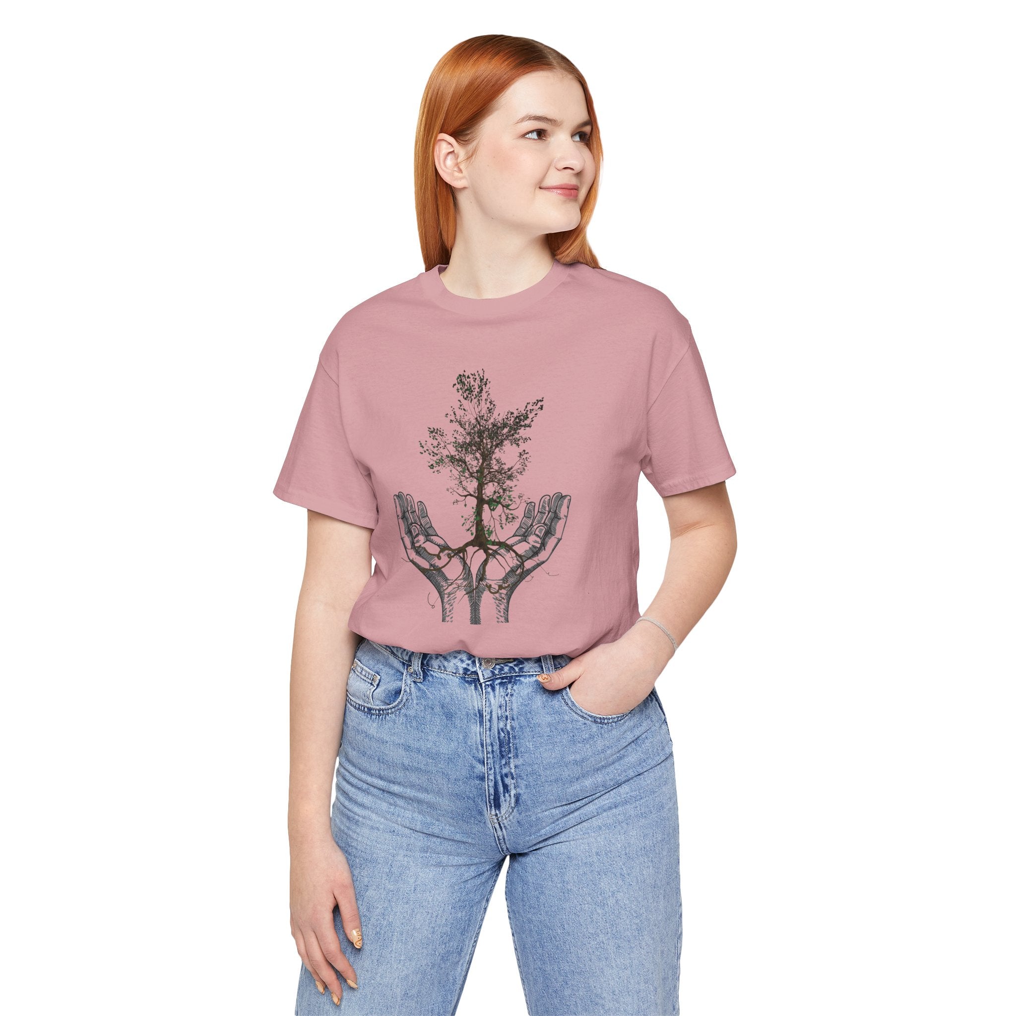 Person wearing a pink t-shirt with a graphic design on a white background