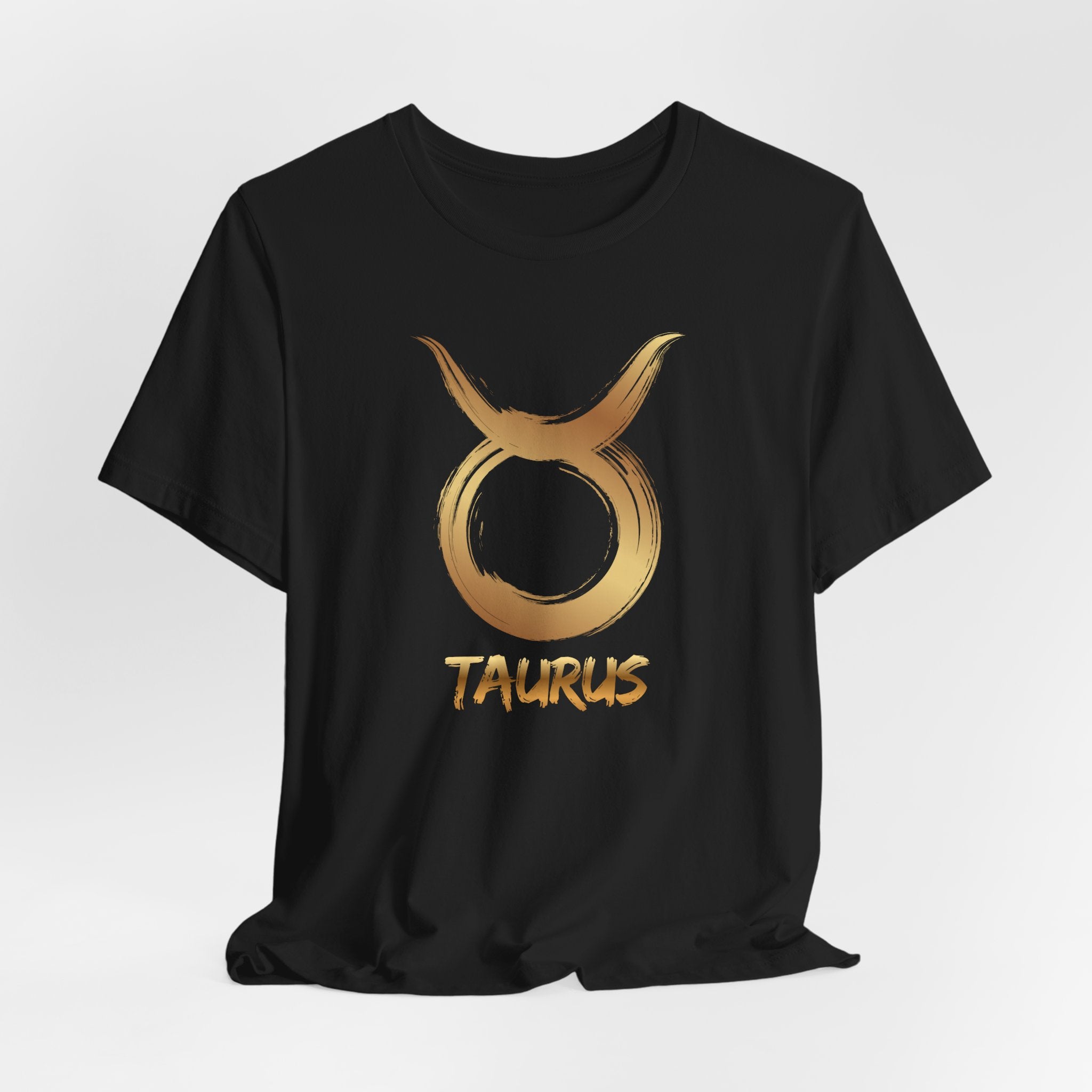 Black t-shirt with gold Taurus zodiac symbol on a white background