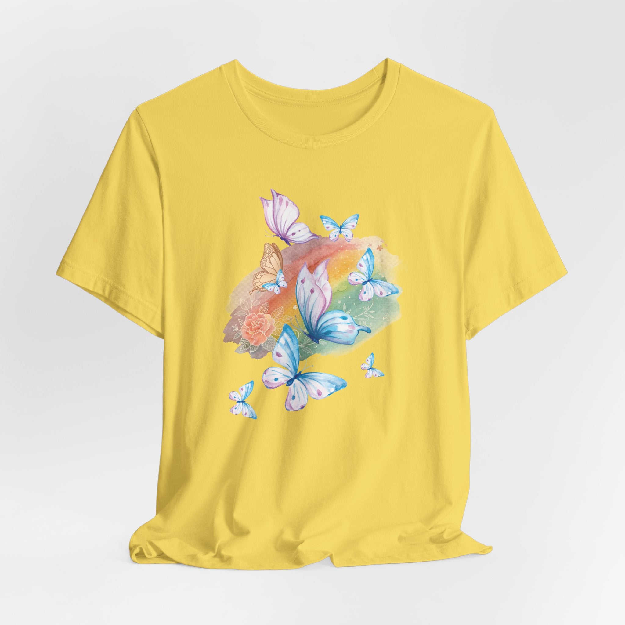 Yellow t-shirt with butterfly and flower design on a light gray background