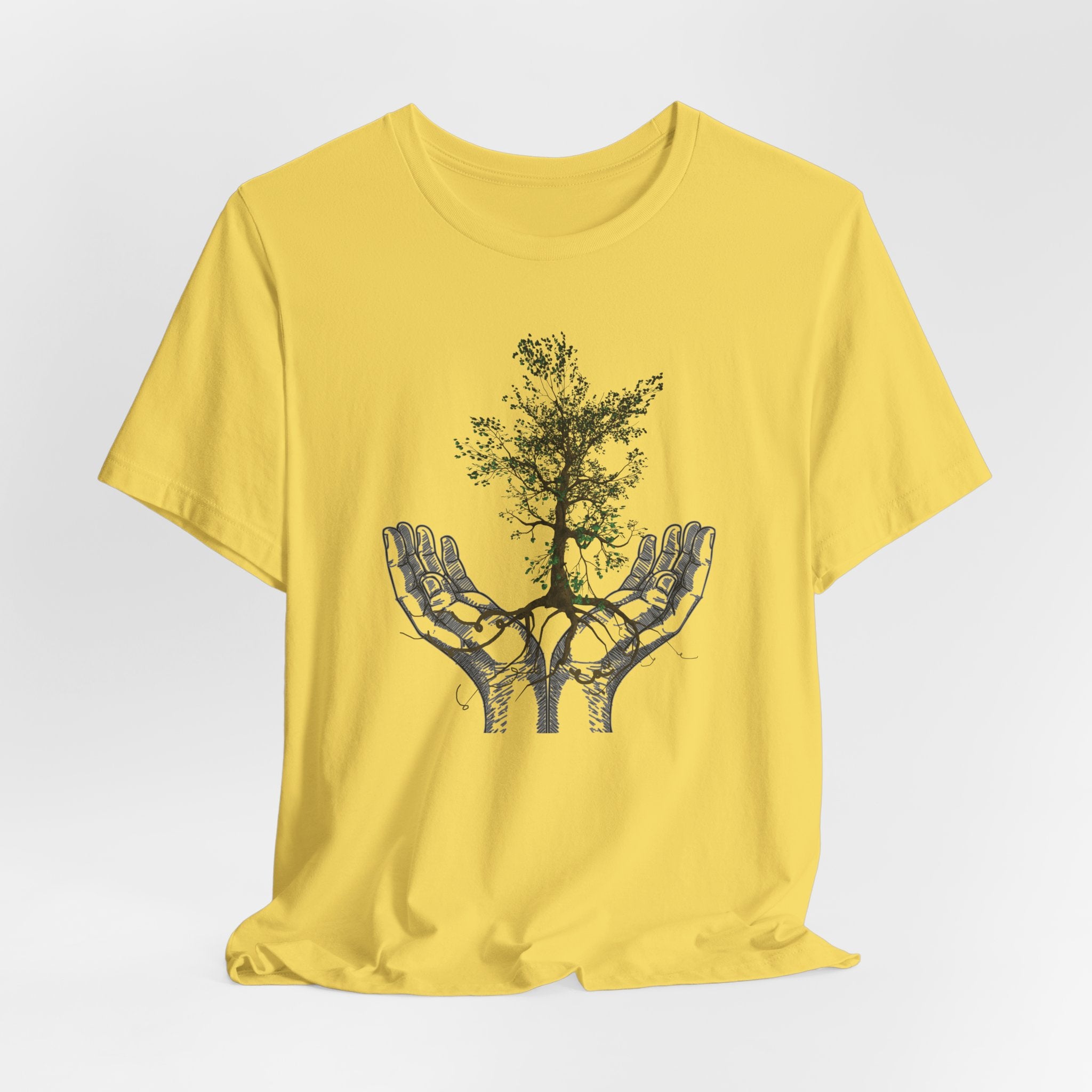 Yellow t-shirt with a graphic of hands holding a tree on a white background