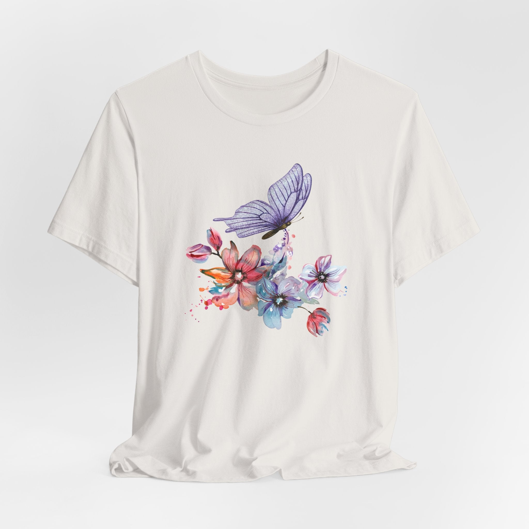 White t-shirt with colorful butterfly and flower design on a white background