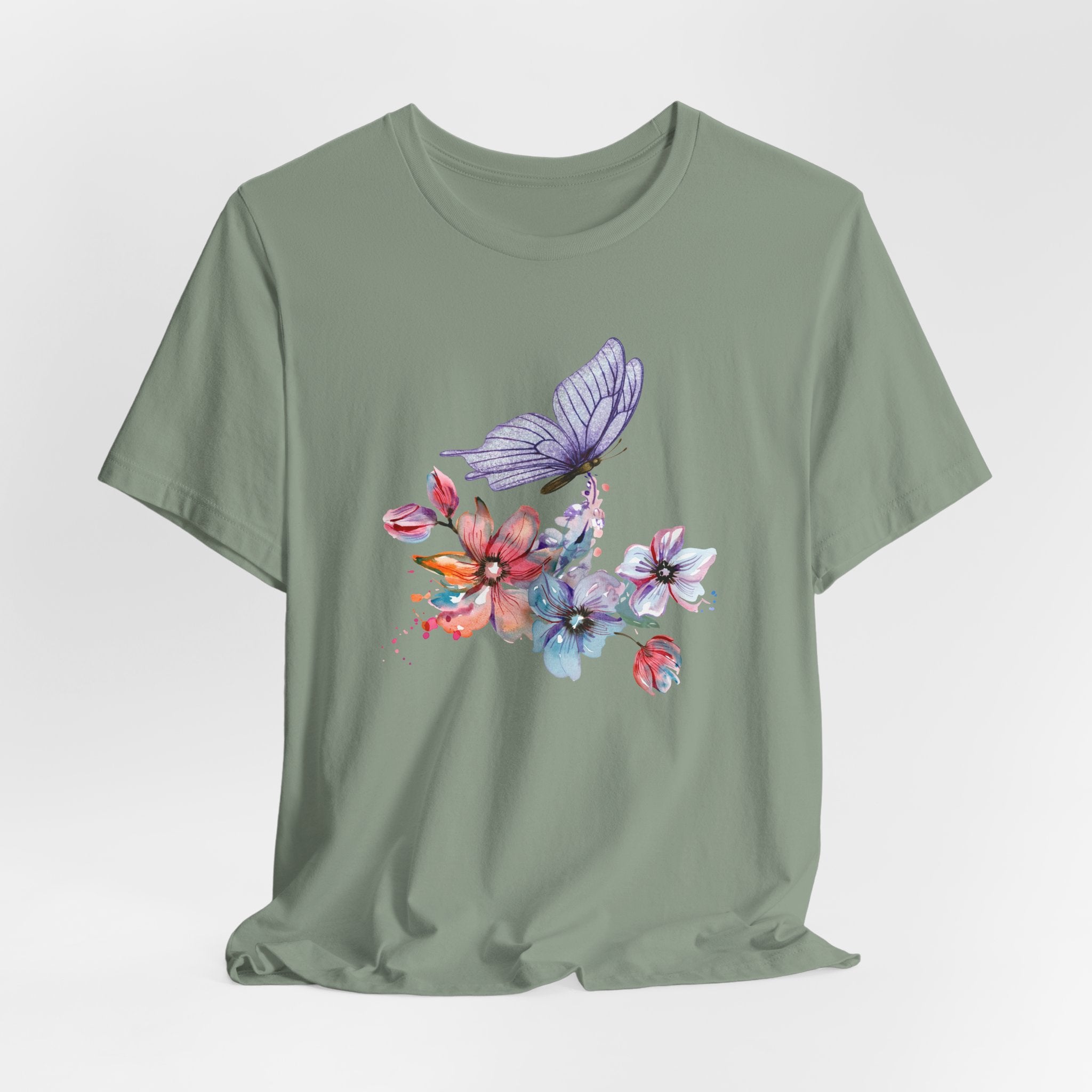 Green t-shirt with a colorful butterfly and floral design on a light gray background