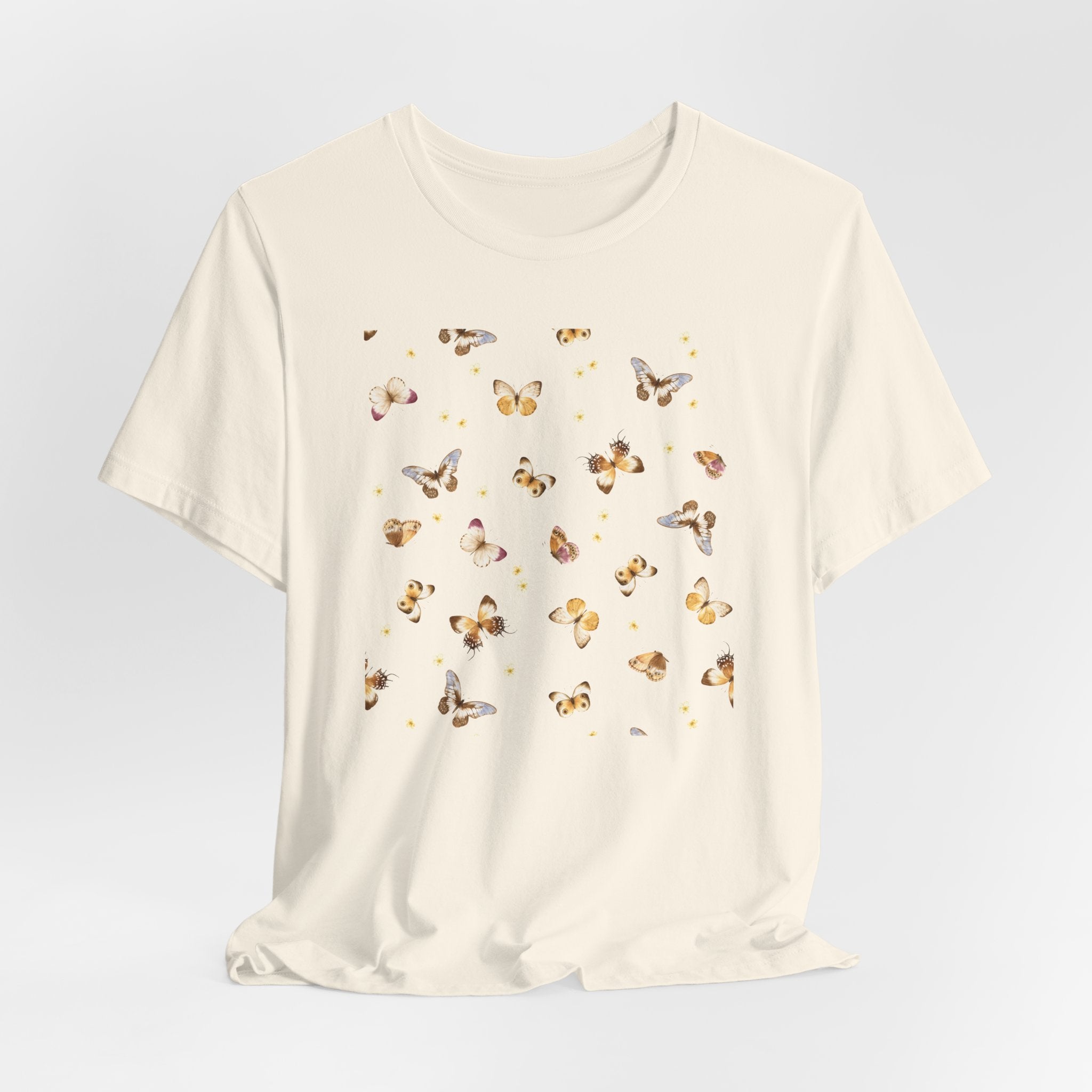 Beige t-shirt with butterfly pattern on a light gray background