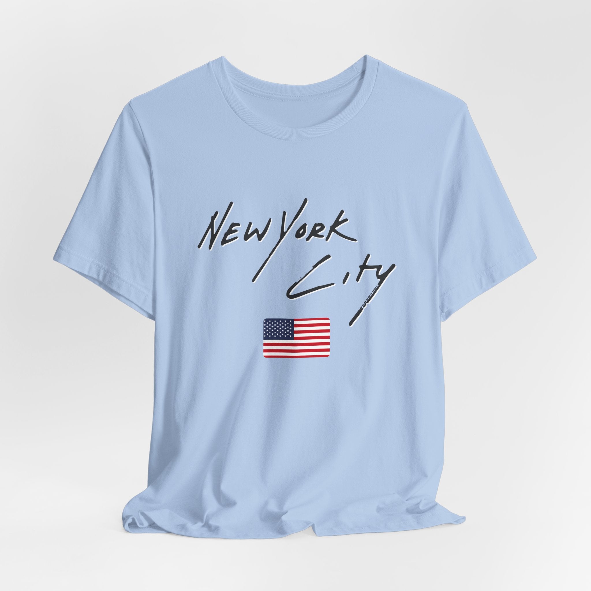 Light blue t-shirt with 'New York City' text and American flag on a light gray background