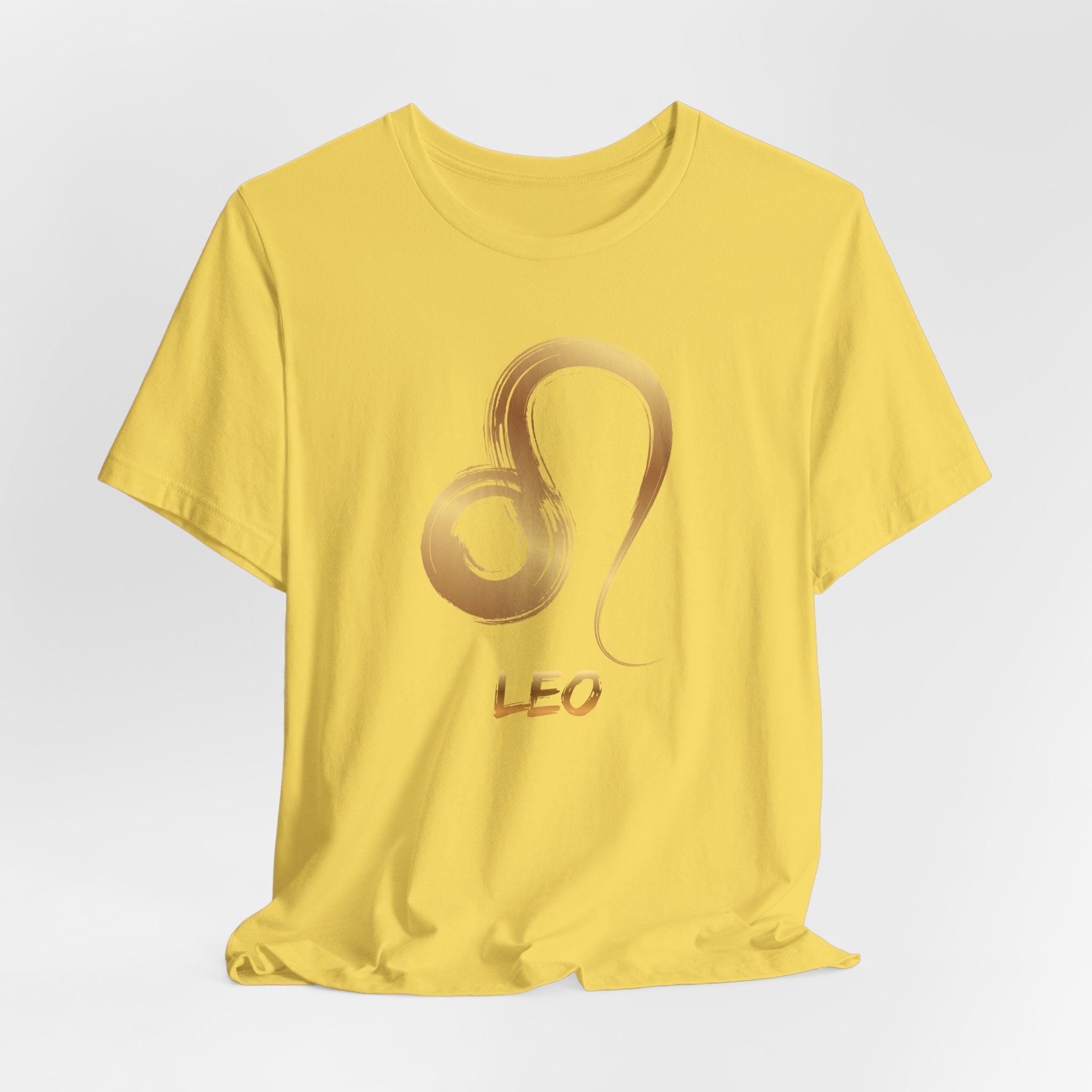 Yellow t-shirt with a gold Leo zodiac symbol on a light gray background