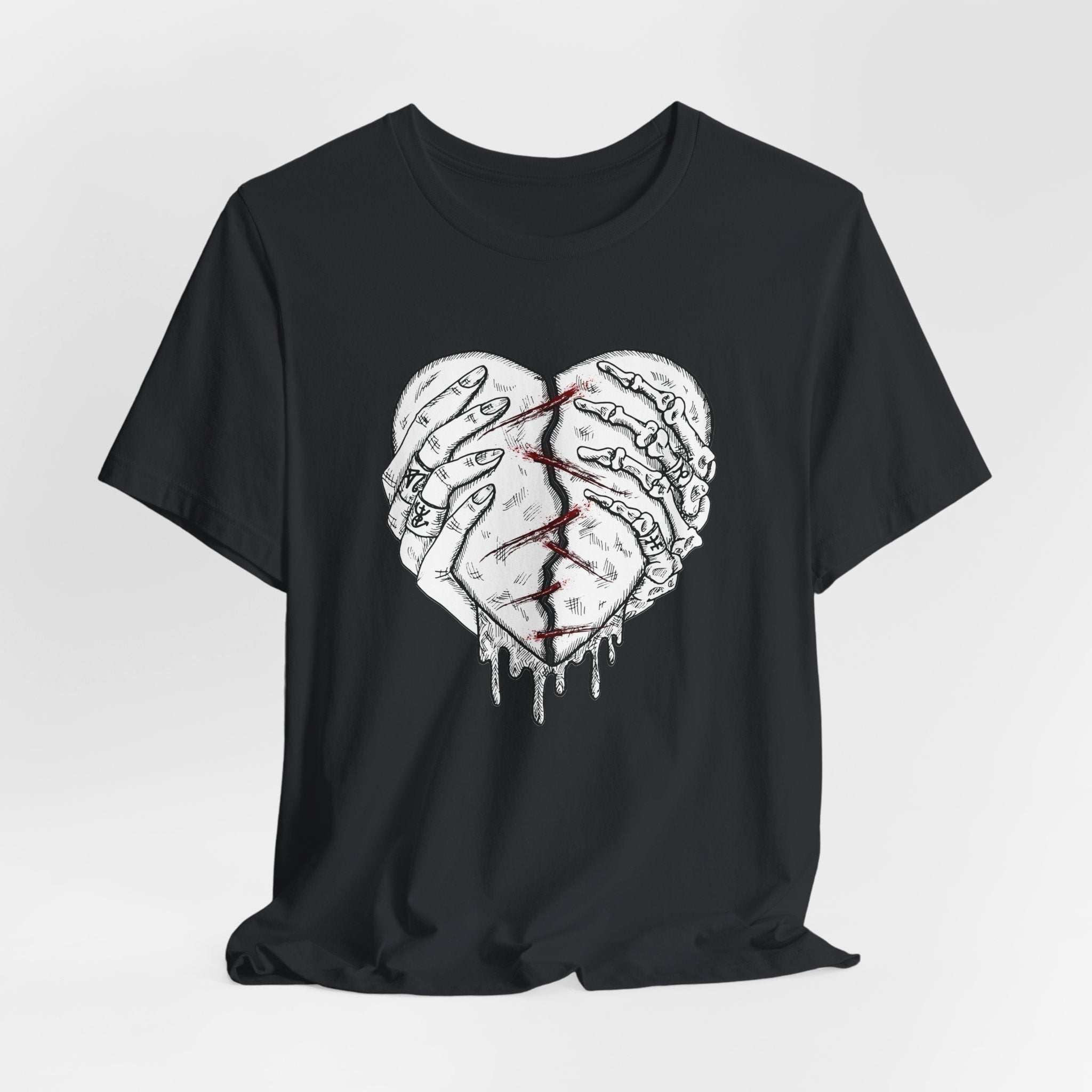Black t-shirt with a graphic design of two hands holding a heart on a white background