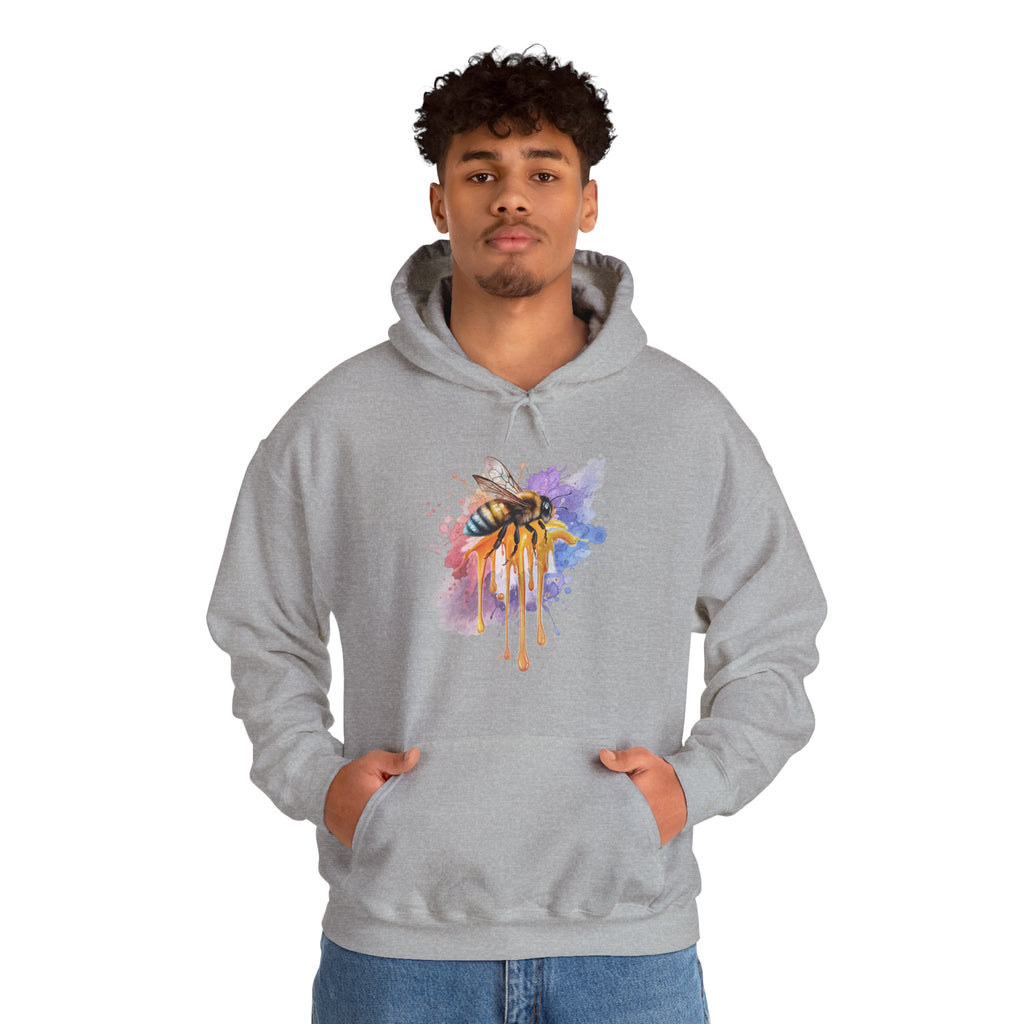 Person wearing a gray hoodie with a colorful bee design on a white background