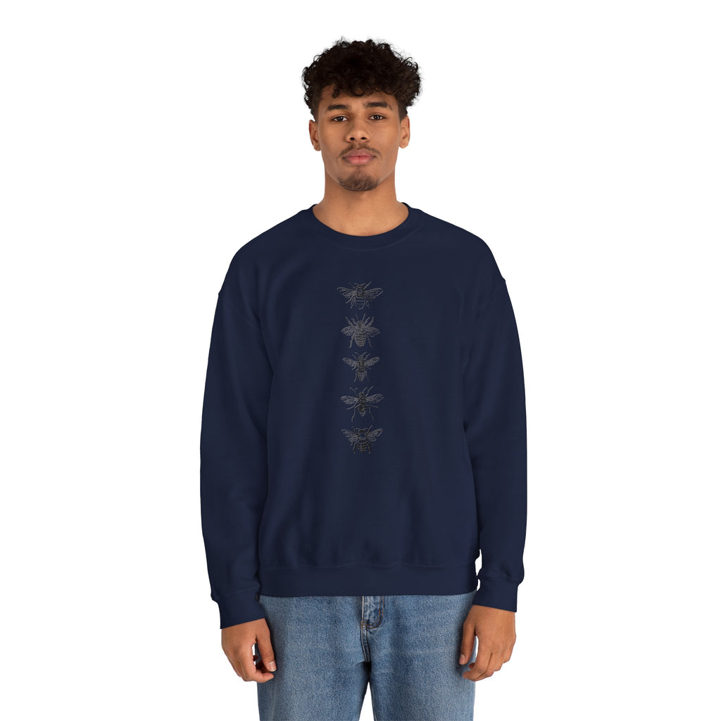 Person wearing a navy blue sweatshirt with black bee illustrations on a white background