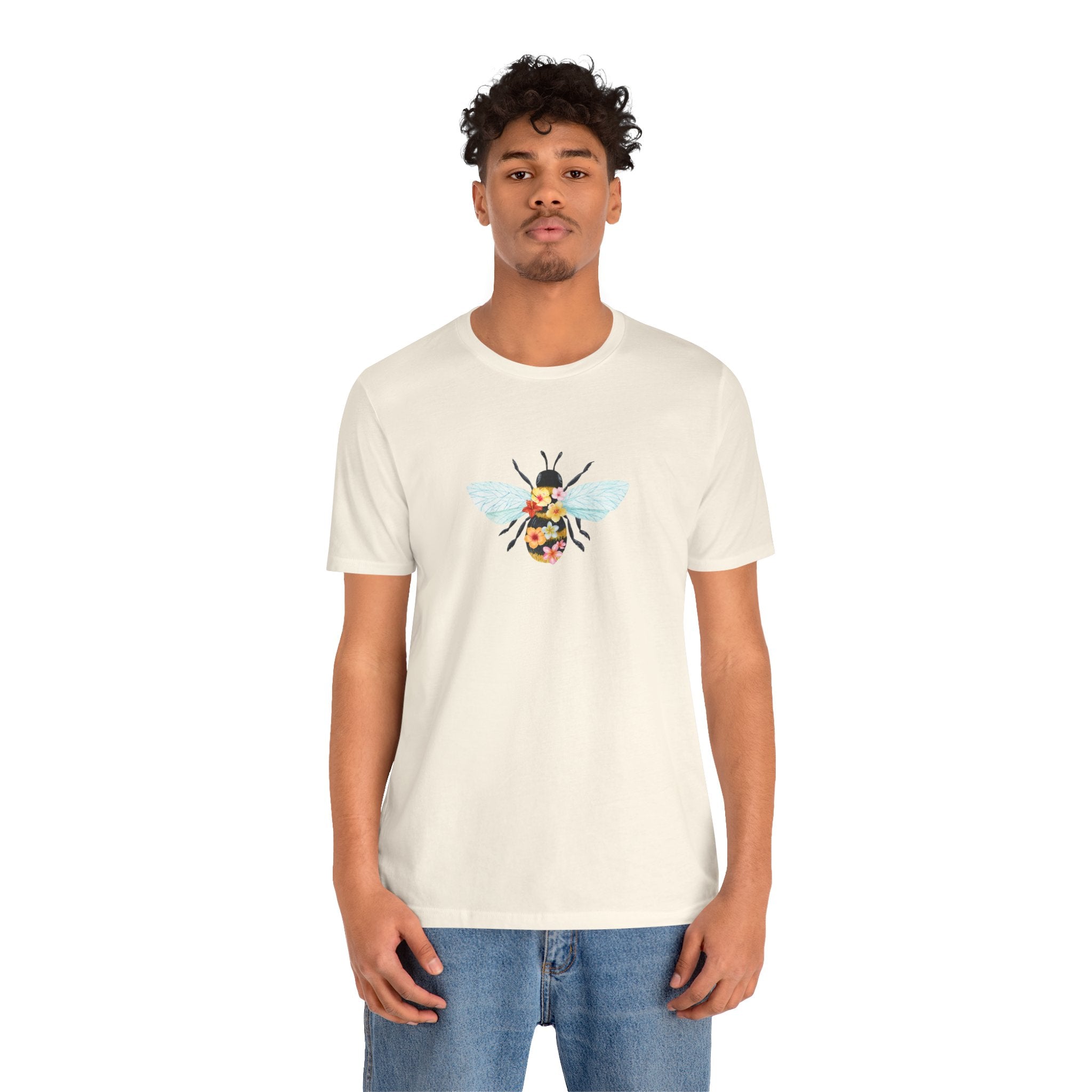 Person wearing a white t-shirt with a graphic design on a white background